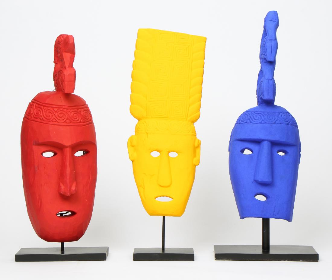 3 Brightly Painted Indonesian Tribal Masks: 3 Brightly Painted Indonesian Tribal Masks. Largest object: 21'' x 7.25'' x 5.5'' (53 x 18 x 14 cm). Height on stand: 24.25" (62 cm).