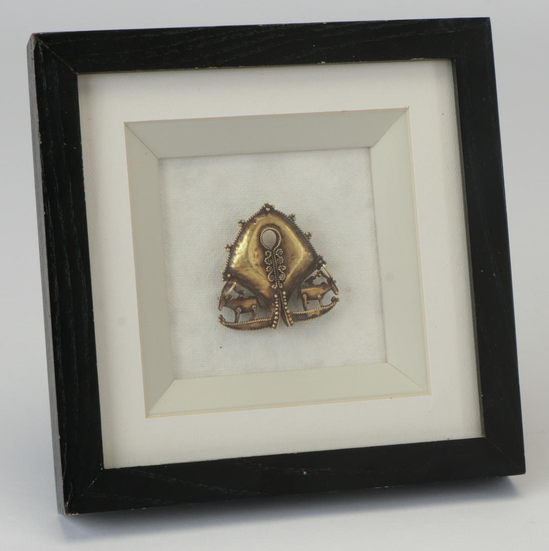 Gold Mamuli, Sumba, Indonesia: Antique Gold Mamuli with fine detail and animal motifs, part of a family's ancestral wealth. Sumba, Indonesia. Size: 2.5'' x 2'', 6 x 5 cm (sight); 8'' x 8'', 20 x 20 cm (frame).