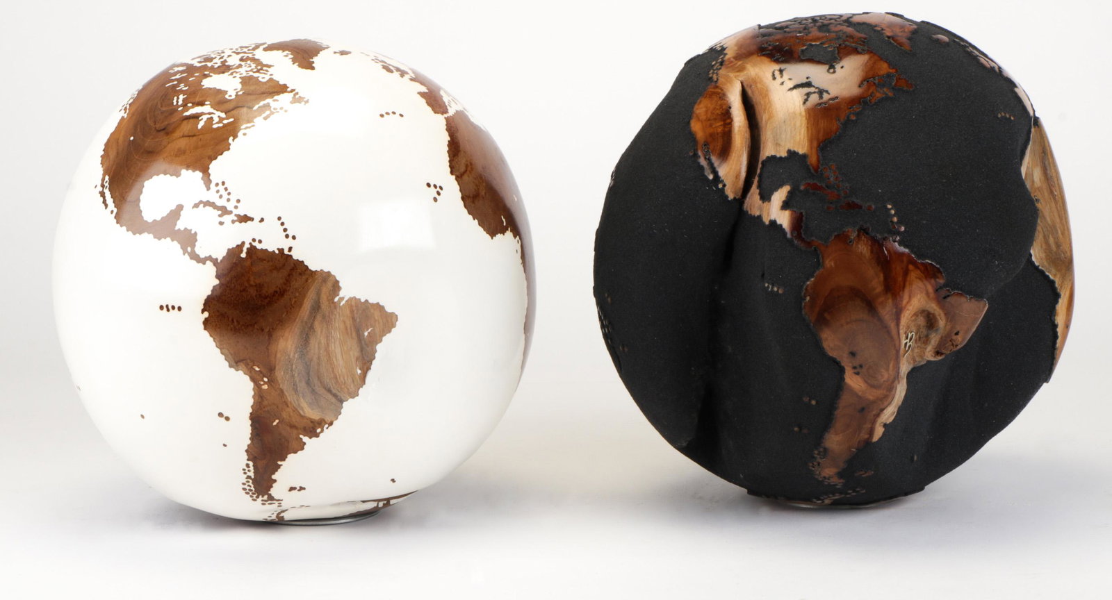 Bruno Helgen (French, b. 1959). Two Teak Wood Root: Bruno Helgen (French, b. 1959). Two Teak Wood Root Globes. (1) White finish. Metallic monogram. Bottom Stamped: 207/2014. (2) Black volcanic sand. Metallic monogram. Bottom stamped: 422/2014. Each on 