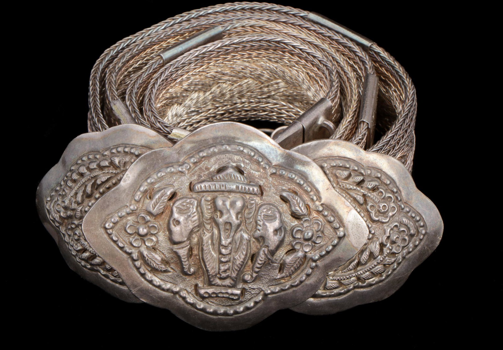 Thai Silver Belt and Buckle: Thai silver belt, buckle with floral and elephant motif and finely braided silver belt 11.23 ozt. Size: 31.5'' x 2'' (80 x 5 cm). Provenance: Private South Carolina Collection. Please Note: There Are 