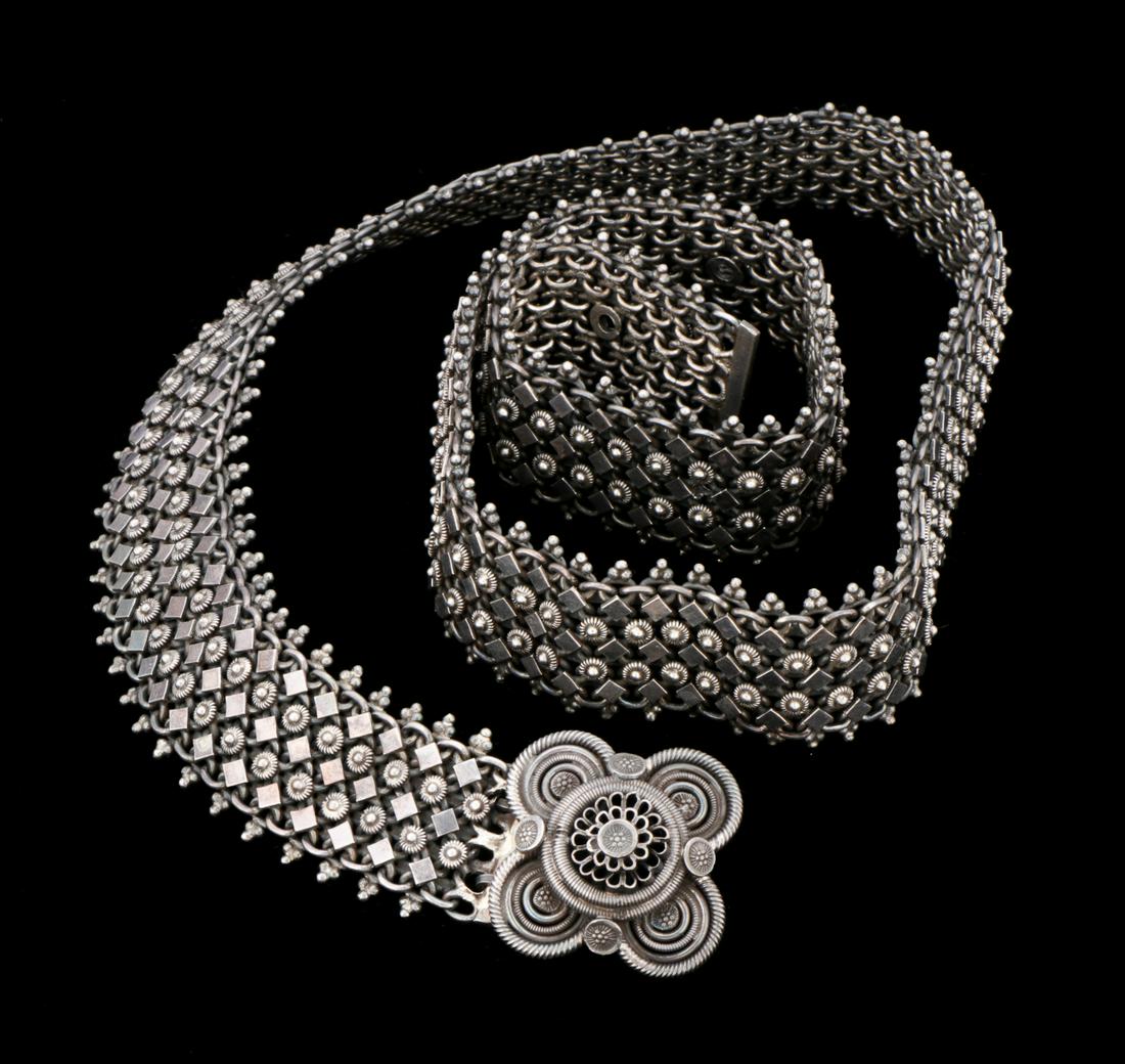 Heavy Thai Silver Belt and Buckle: Very heavy old Thai silver belt with flower buckle composed of coiled silver and highly detailed linked silver chain belt. 11.49 ozt. Size: 34'' x 1.75'' (86 x 4 cm). Provenance: Private South Carolin