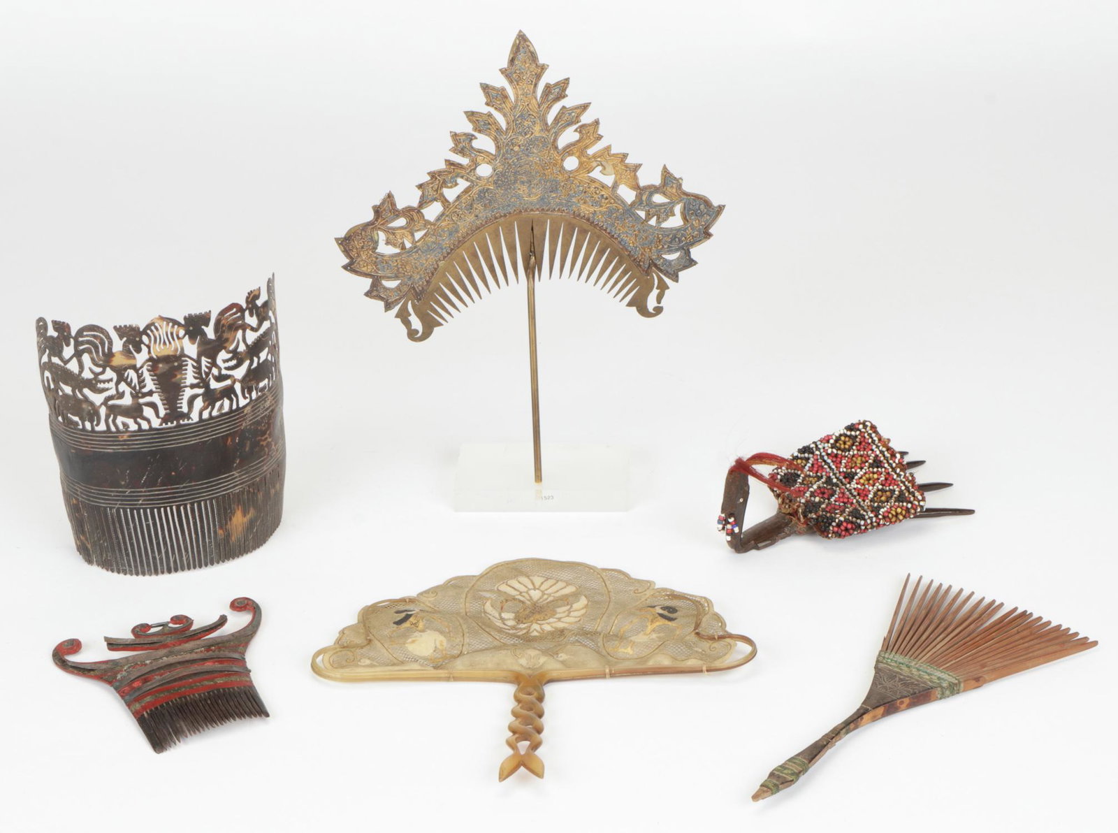 Fine Collection of Indonesian Decorative Combs (6): Fine Collection of Indonesian Decorative Combs. From Bali, Sumatra, Timor, East Sumba and Java, including a hand fan with bird and wayang figures, pierced buffalo hide and carved horn, first half 20th