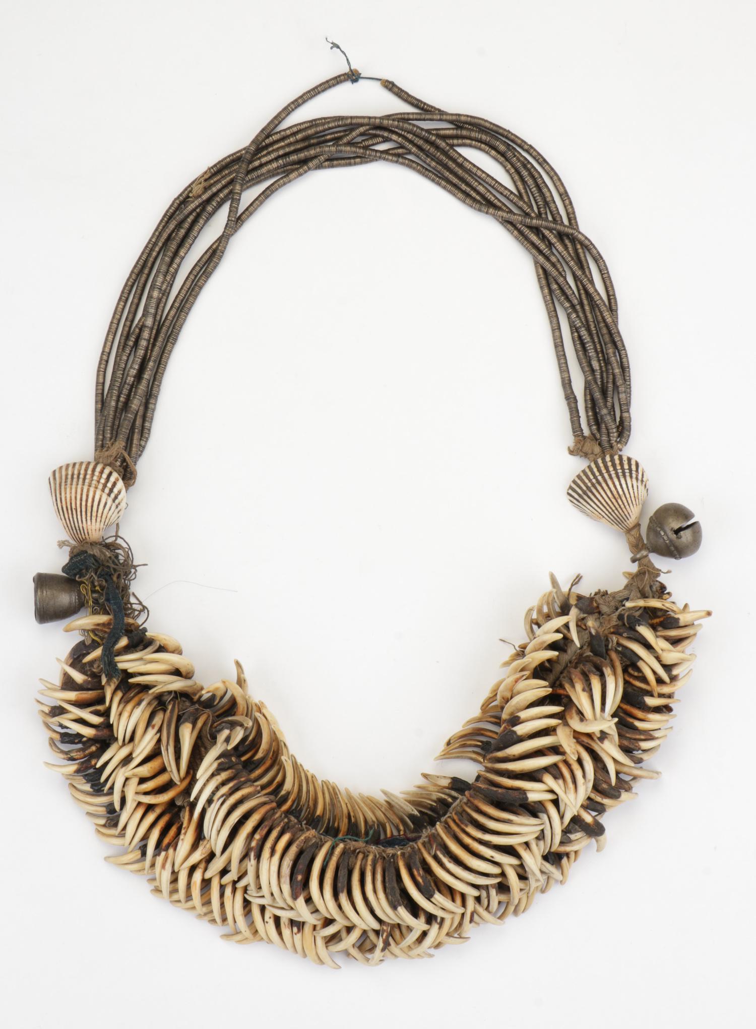 Burmese Chin People "Hla ha" Deer Teeth Neck Ornament: Burmese Chin People "Hla ha" Neck Ornament of teeth of the muntjac deer, metal rings, and shells. Collection of Allan Stone, New York. Size: 22'' (56 cm). Please Note: There Are No Hidden or Confident