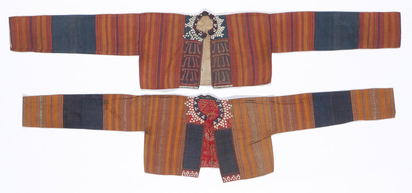 Two Antique Kauer Ceremonial Women's Jackets: Two Antique Kauer Ceremonial Women's Jackets. "Bajuh monyet", cotton, silk thread, shells, couched metallic thread, bangles, early 20th century, Kauer people, Lampung, Sumatra, Indonesia. Sizes: 1) 12
