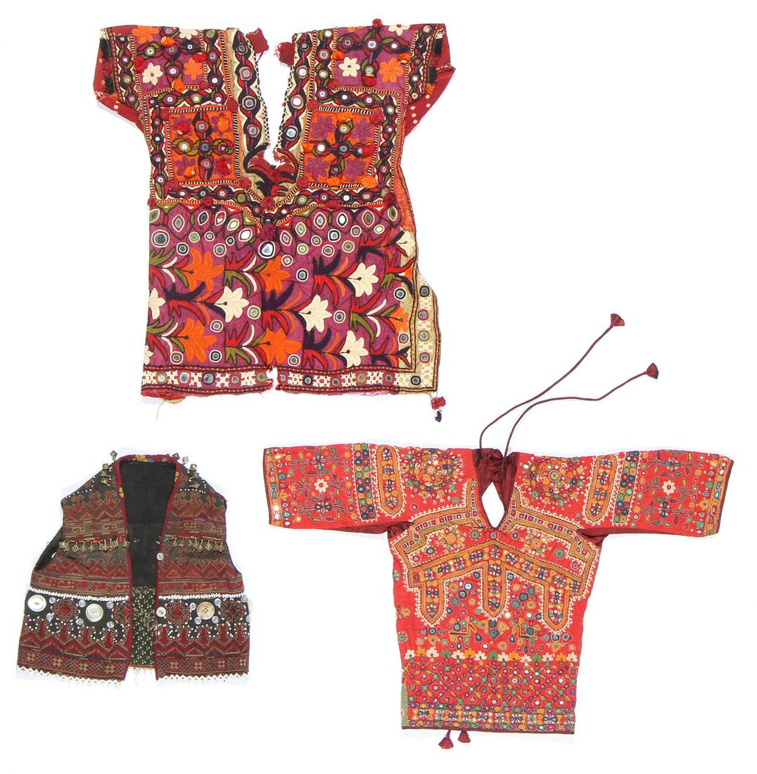 Three Ethnographic Textile Tops: Three Ethnographic Textile Tops. Including a child's vest, mixed media, Kohlistan, Indus Valley; and 2 choli blouses, embroidered with couched mirrors on cotton ground, Banjara people, Rajasthan, Indi