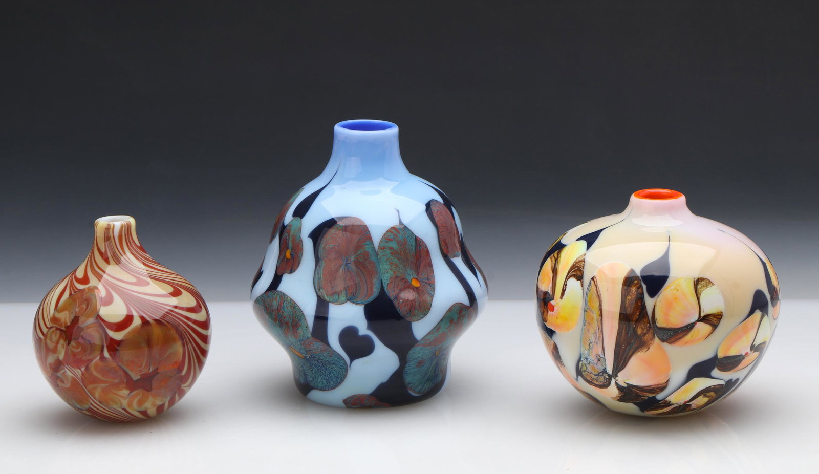 George Thiewes (b. 1943) Art Glass Group (3): George Thiewes (American, b. 1943) Art Glass Group. Three Vases. Sizes ranging from: 4.25'' x 3.5'' x 3.5'' (11 x 9 x 9 cm). to Size: 5.75'' x 5'' x 5'' (15 x 13 x 13 cm).