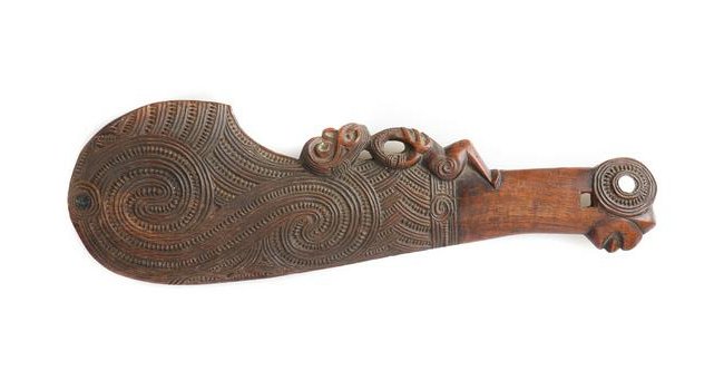 Maori Carved Wood Wahaika Ceremonial Club: Maori Carved Wood Wahaika Ceremonial Club. The curved blade with deeply carved linear design and with a tiki figure on the inside, the handle end in the form of a stylized mask with mother-of-pearl in