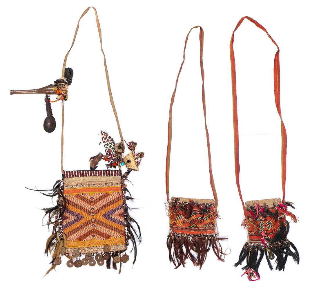 Three Antique Indonesian Bags, West Timor, late: 3 cloth bags, cotton, tapestry weave, twining embellished with beads, one with beaded lime holder for betel nut, wood spoon, old coins, bone, bells and other amulets, West Timor, late 19th/early 20th 
