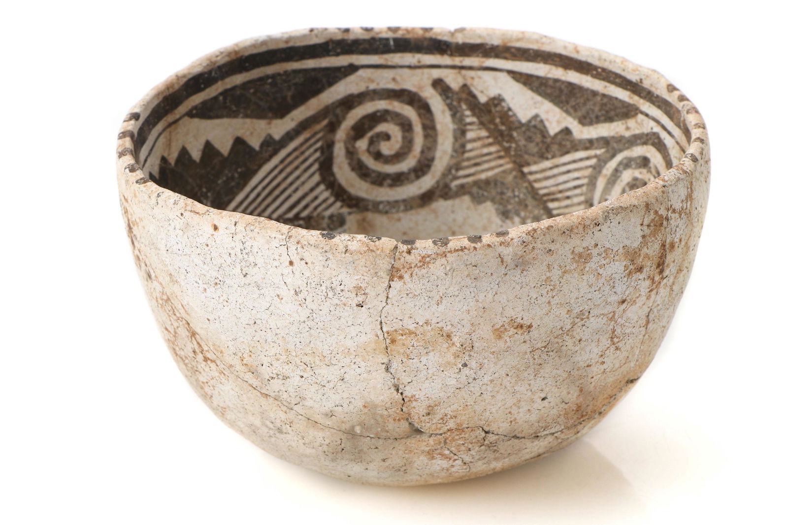 Native American Anasazi Pottery Bowl: Native American Anasazi Pottery Bowl. Black on white geometric and swirl designs. Restorations. Provenance: R.G. Munn, Mayhill, MN, January 14, 2014, Lot 122. Size: 4'' x 6'' x 6'' (10 x 15 x 15 cm).