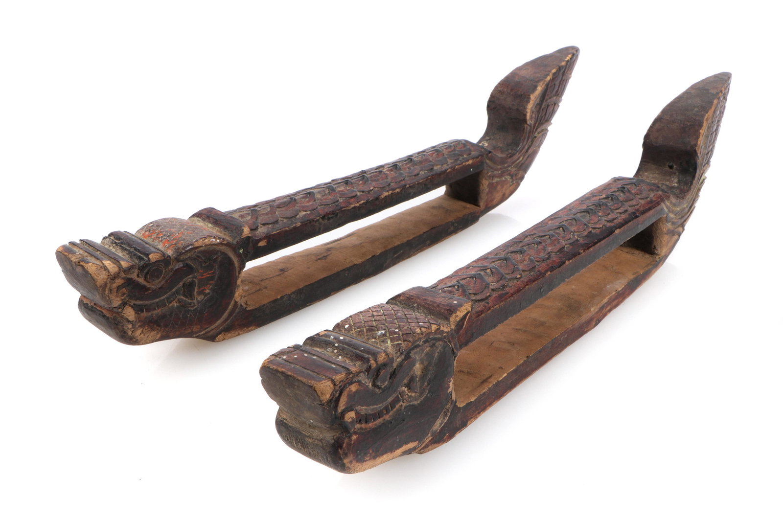 Pair of Carved Cambodian Loom Warp Board Guides: Pair of loom warp board guides carved into the heads and tails of dragons, Cambodia, circa 1900. Each Size: 2.5'' x 16.5'' x 3.75'' (6 x 42 x 10 cm). Note: There Are No Hidden or Confidential Reserves