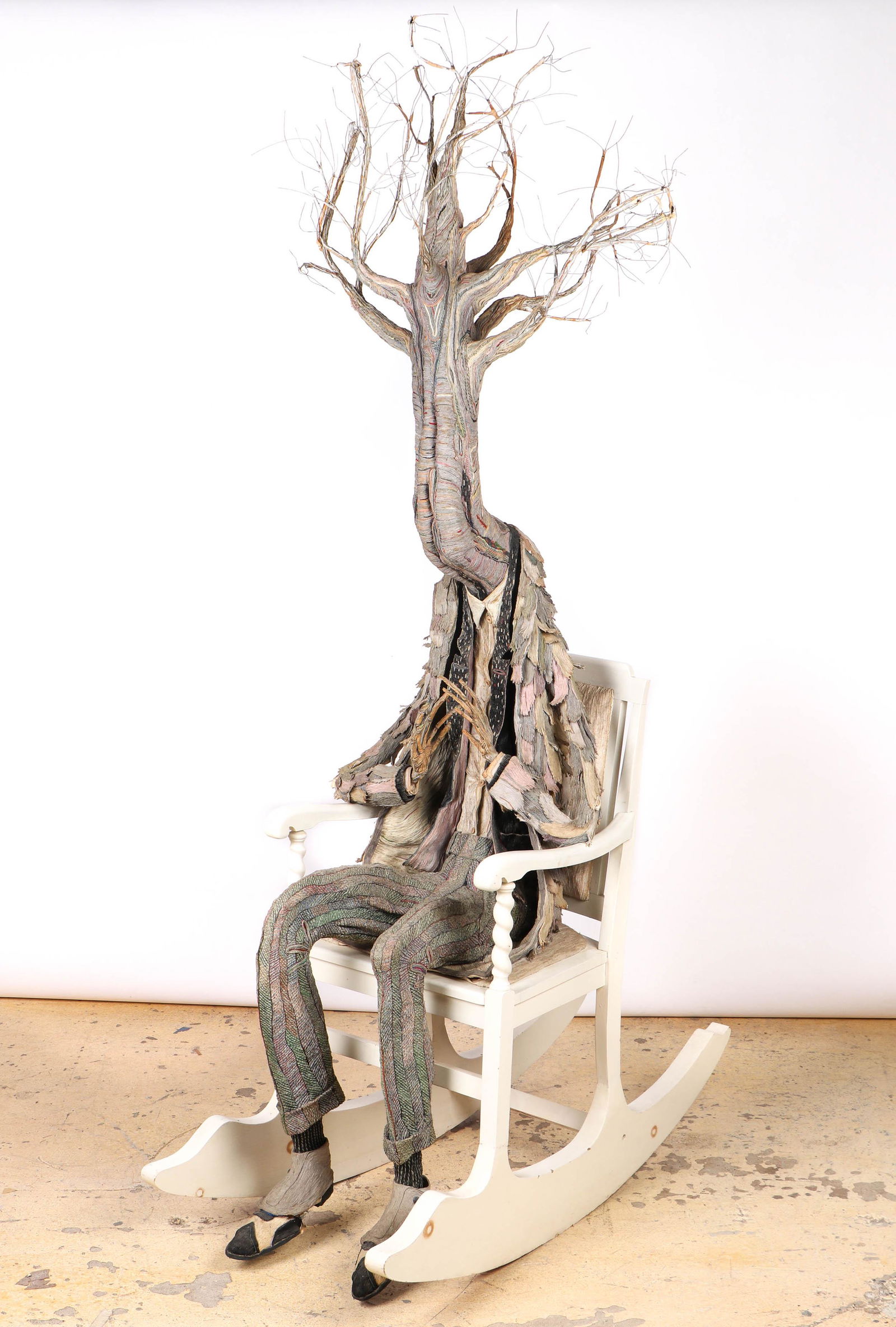 James Grashow (American, b. 1942) Sculpture: James Grashow (American, b. 1942) Untitled from "The Woods" c.1979, fabric mache, thread, cardboard and rocking chair. One shoe detached. Size: 98'' x 24'' x 50'' (249 x 61 x 127 cm). Provenance: Coll