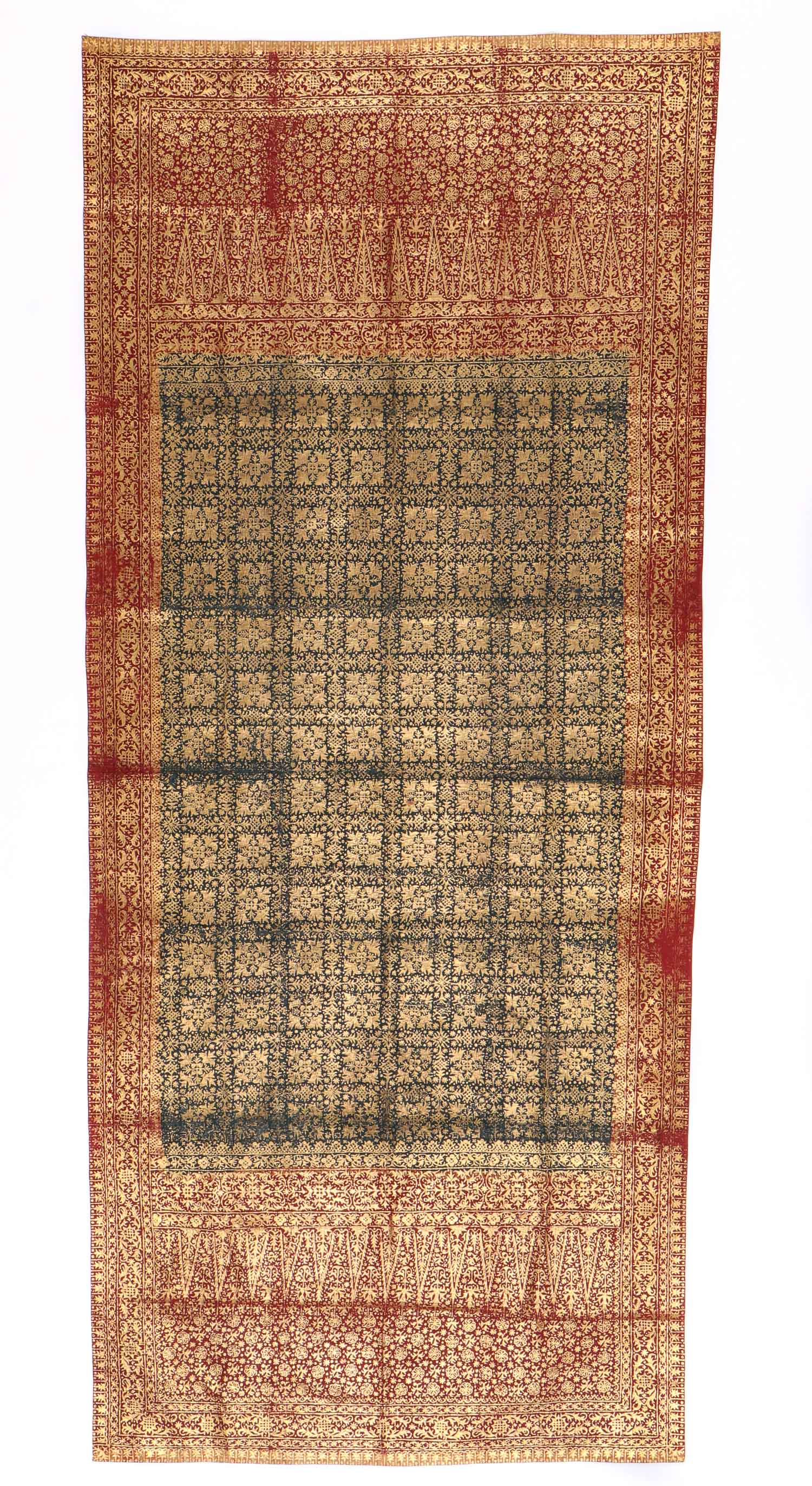 Antique Kain Prada Selendang Batik Skirt Cloth: Batik and applied gold-painting, "Kain Prada Selendang", on a cotton fabric. A large rectangular center field with solid blue coloring with yellow zigzag border. Side and end sections of solid red. A 
