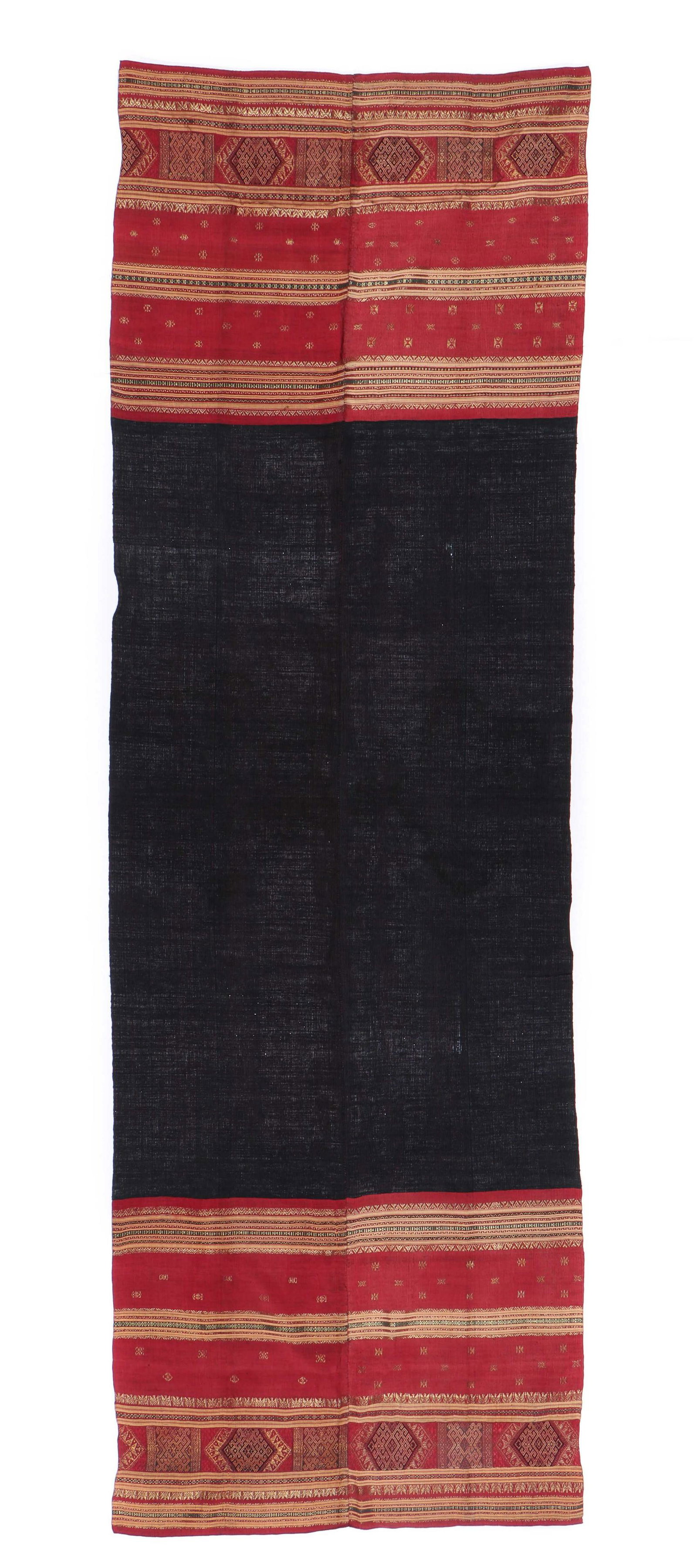 Fine Indonesian Cotton Sarong, Late 18th/Early 19th c.: Sarong made from two strips of fabric with indigo and red cotton warps, sewn together along selvage edges. On each end there are red silk wefts with stripes of continuous and discontinuous supplementa