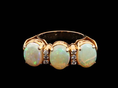 14kt Yellow Gold Opal and Diamond Ring: 14kt Yellow Gold Opal and Diamond Ring. Weight: 9.83 g. Size: .75" Diameter; Stone Portion: .5'' x 1.5'' (1 x 4 cm). Ring Size: 8. Provenance: Estate of Aviva and Jack Robinson, Bloomfield Hills,