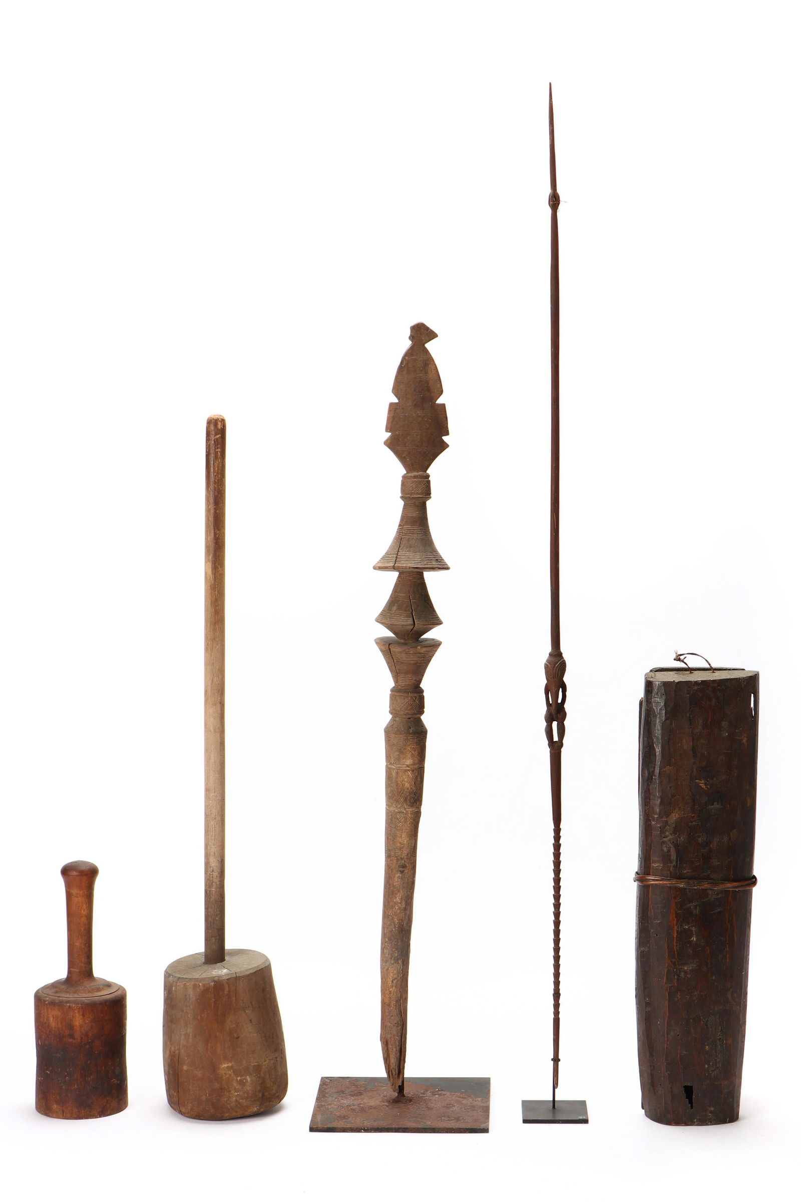 Ethnographic Group Lot: Multicultural Ethnographic Group. Including: a Sepik River Lime spatula, a Taureg "ehel" tent peg, two African pounders and a wood container. Provenance: Collection of Allan Stone, New York. Ranging i