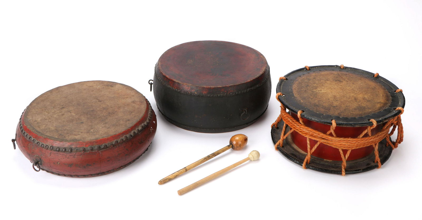 Three Antique Chinese Drums and 2 Sticks, 19th C.: Three Antique Chinese Drums and 2 Sticks, 19th C. Ranging in Size from: 7'' x 13'' x 13'' (18 x 33 x 33 cm) to 10.5'' x 1'' x 1'' (27 x 3 x 3 cm).