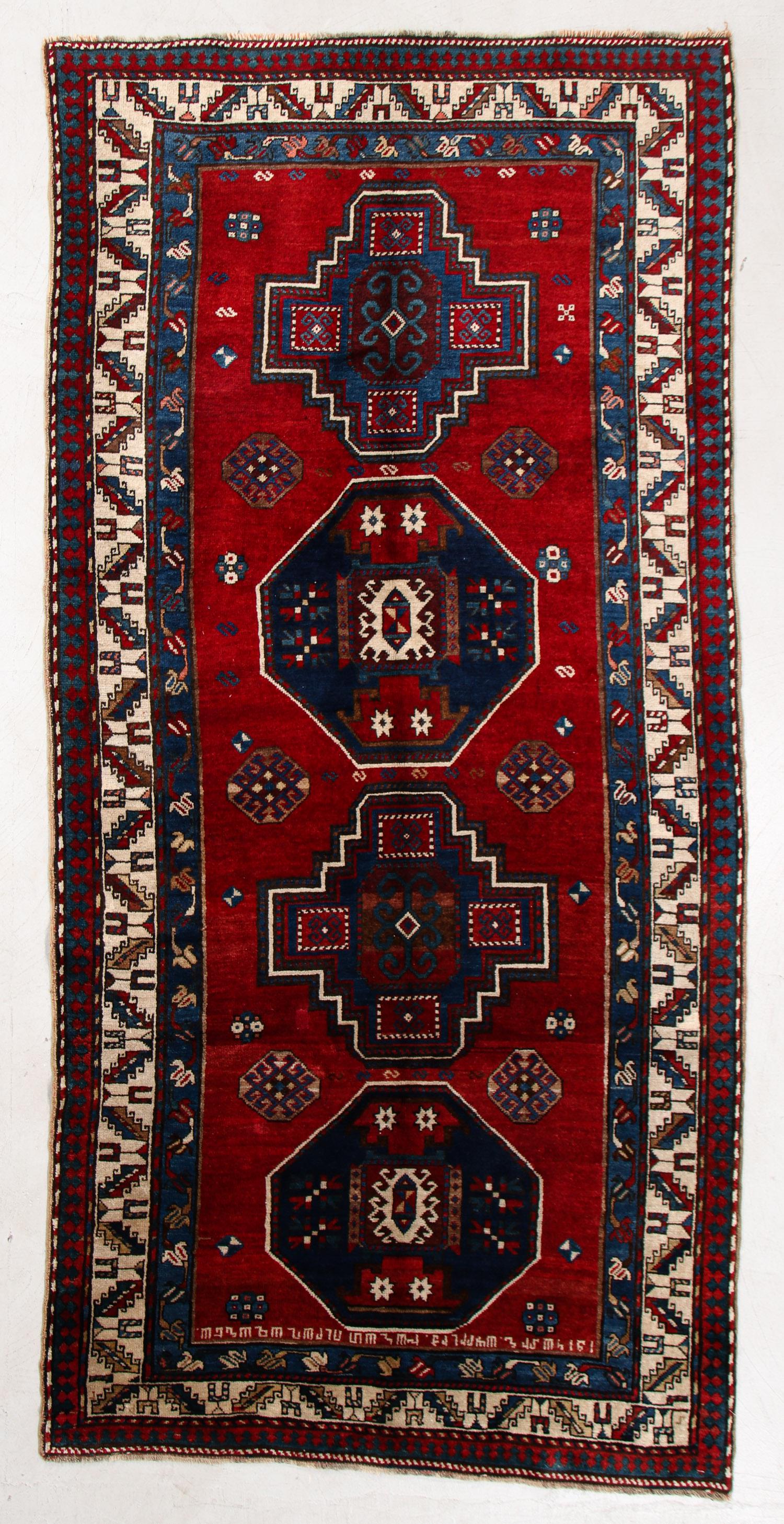 Armenian Inscribed Kazak Rug, Caucasus, Early 20th C.,: Armenian Inscribed Kazak Rug, Caucasus, Early 20th C., 4'8'' x 9'4'' (142 x 284 cm). Weight: 25 lbs. Material: wool pile, wool warp, wool weft.