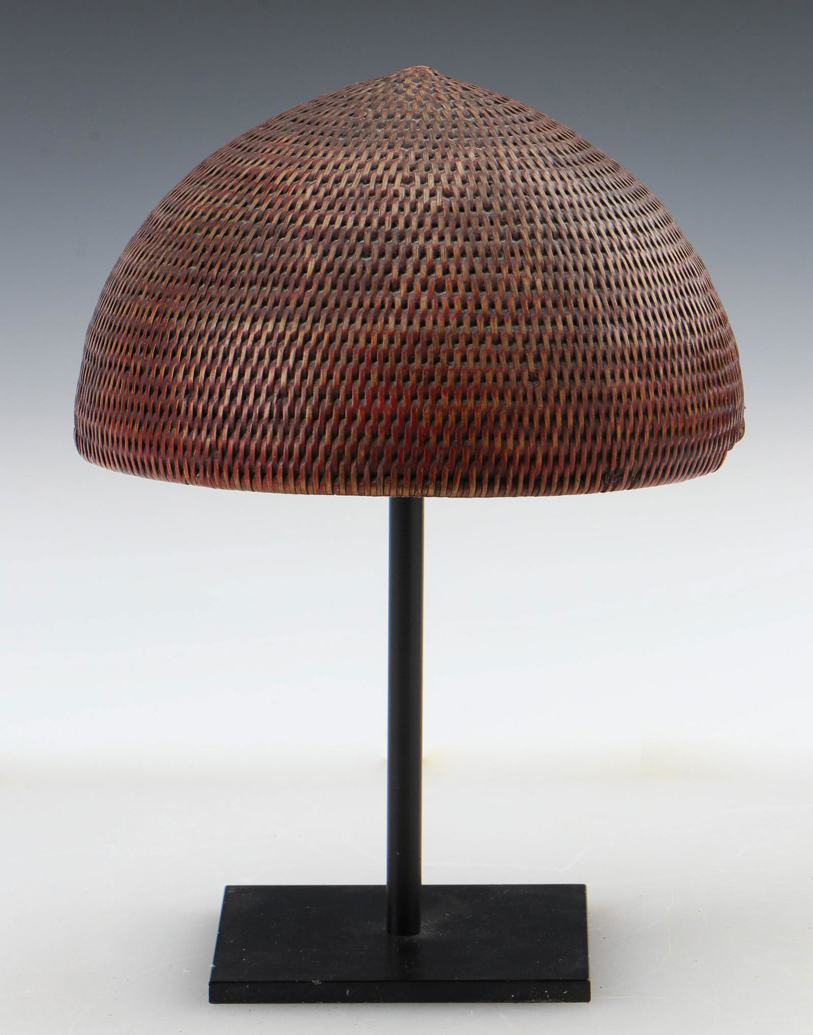 Antique Dome-Shaped Basketry Helmet: Antique Dome-Shaped Basketry Helmet, possibly Northeastern India frontier, Assam, late 19th/early 20th C. On stand. Size: 3.5'' x 7.5'' x 7'' (9 x 19 x 18 cm); Height on Stand: 9.5" (cm). Ex. Cathryn