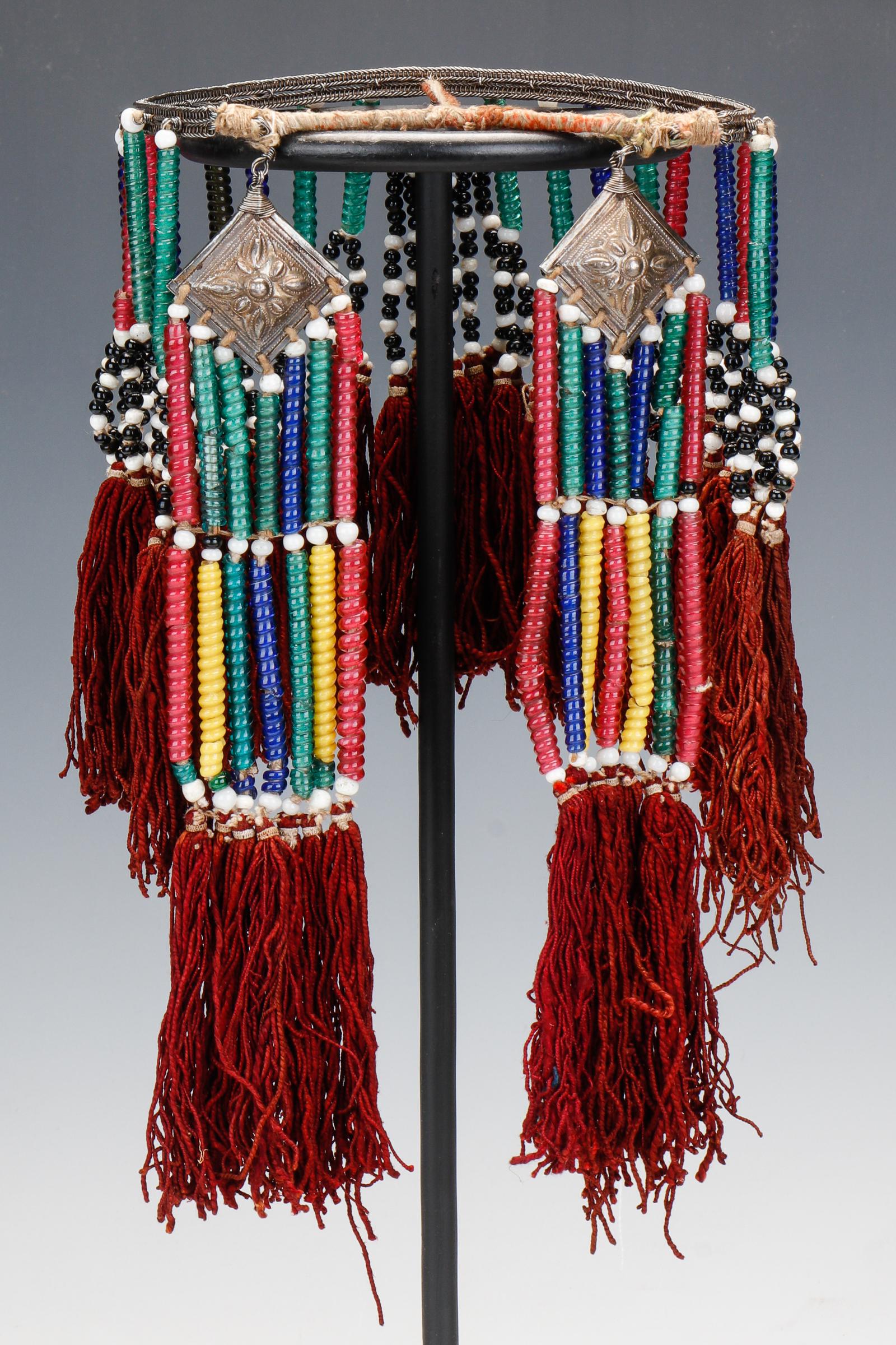 Jinxiu Yao Woman's Headdress, China, Early 20th C.: Jinxiu Yao Woman's Headdress, China, Early 20th C. With tubular glass beads, silver pendants, cotton tassels and twine-wrapped wood. Size: Band: 6" (15 cm) diameter; Pendant Tassel: 10" (25 cm) longes