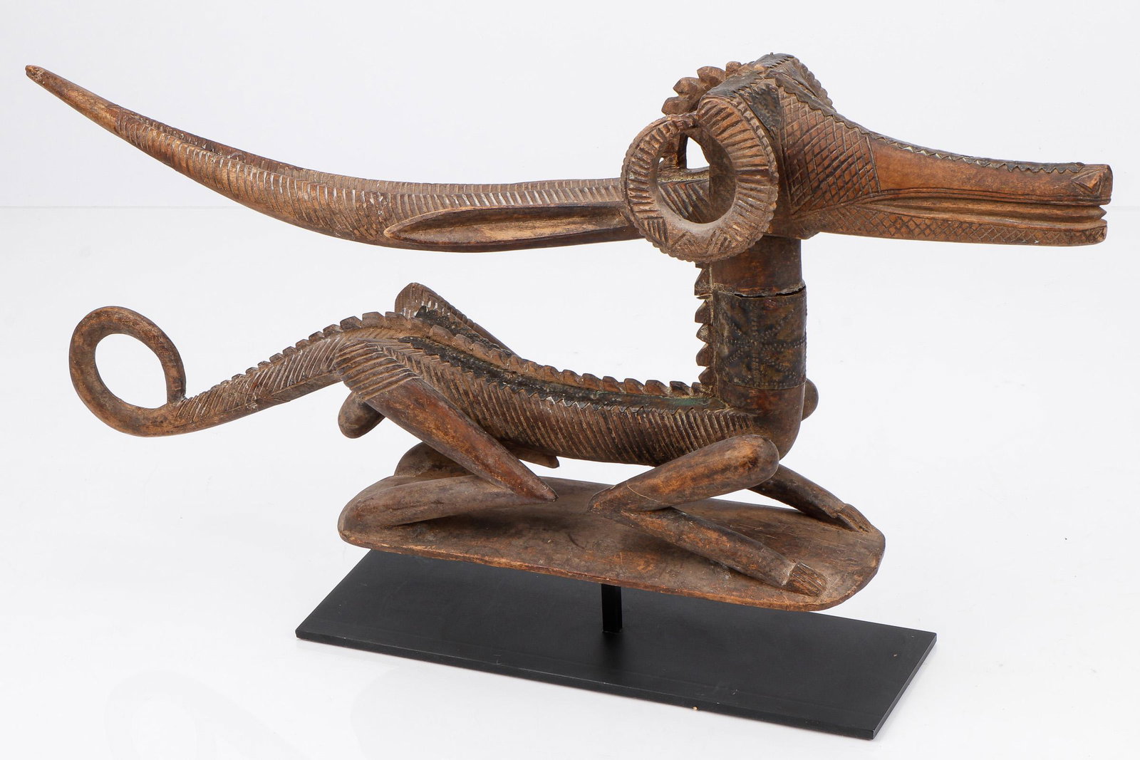 African Bambara Chiwara Headdress, Mali: African Bambara Chiwara Headdress, Mali. Carved wood, metal. Ex. Collection William and Diane Bousquette, Purchase, New York. Size: 7.25'' x 21.25'' x 4.5'' (18 x 54 x 11 cm). Height on stand: 10.5" (