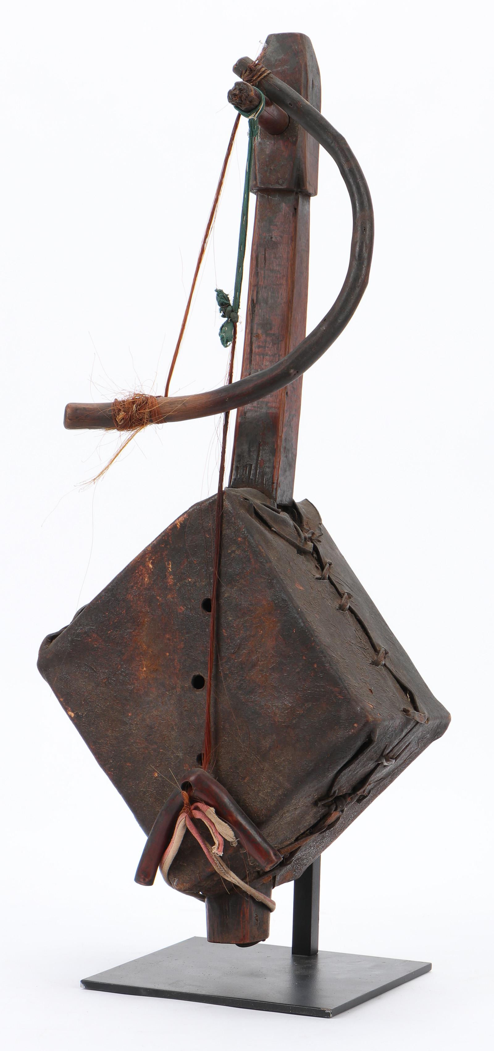 Antique Ethiopian Lute and Bow: Antique Ethiopian Lute and Bow, 19th/Early 20th C. Carved wood and animal hide. On stand. Size: 27'' x 11'' x 7.5'' (69 x 28 x 19 cm). Height on Stand: 28" (71 cm).