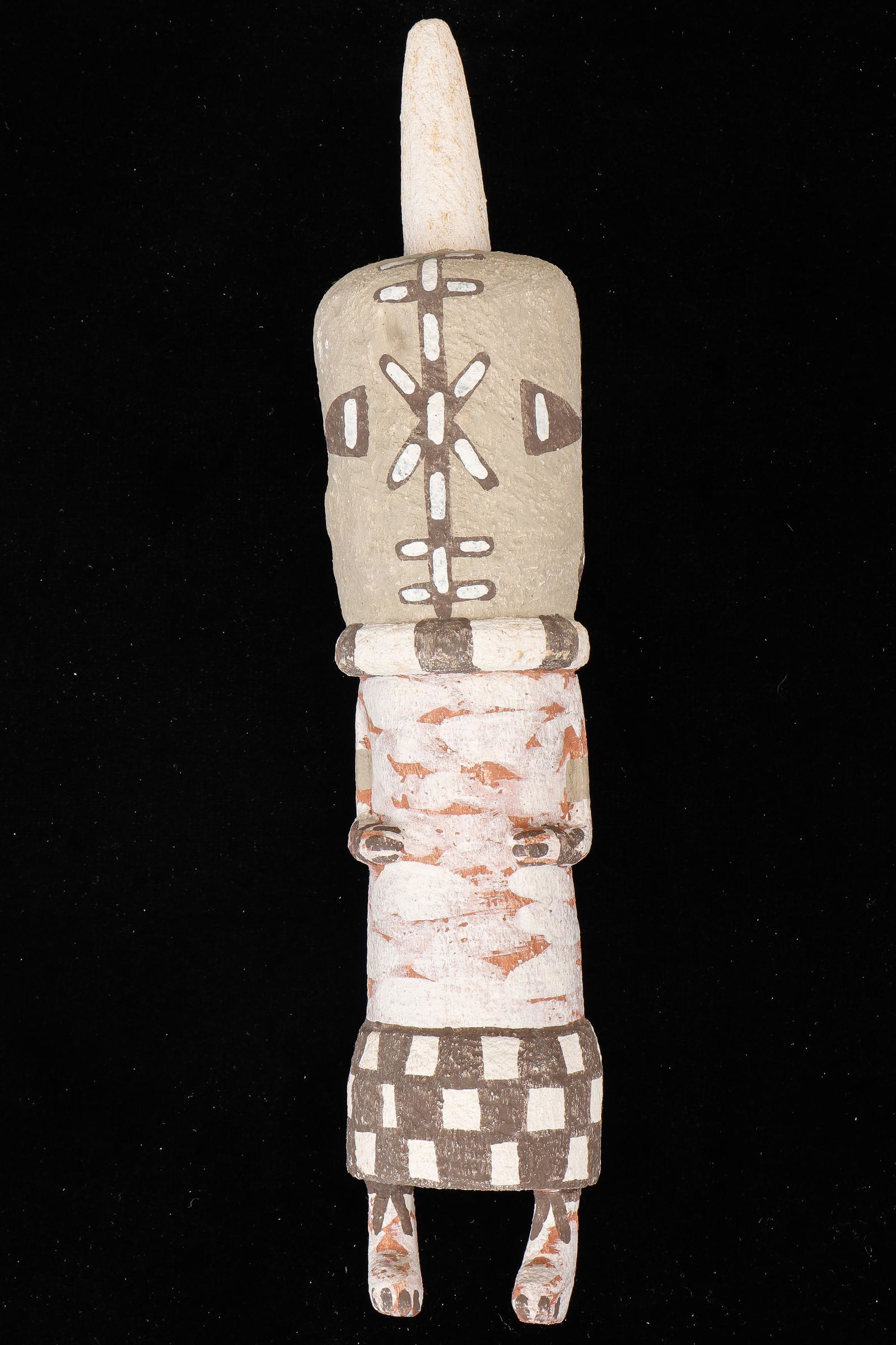 Native American Hopi Kachina by Manfred Susunkewa (B.1940): Native American Hopi Kachina by Manfred Susunkewa (B.1940) "Aya," Carved cottonwood with pigment. Size: 12.25'' x 2.5'' x 2.5'' (31 x 6 x 6 cm).