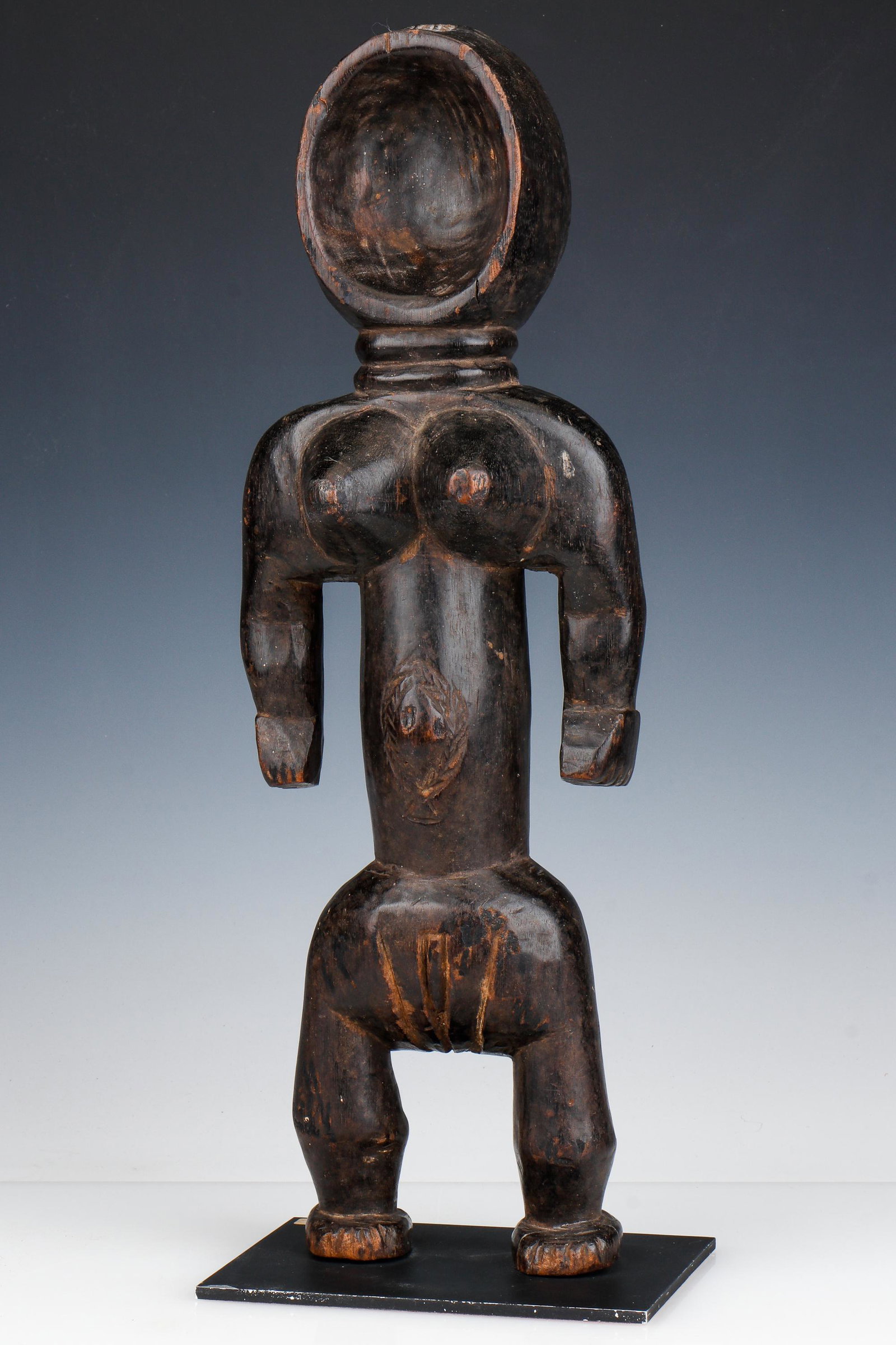 African Dan Figure, Ivory Coast: African Dan Figure, Ivory Coast. Carved wood. On stand. Provenance: Ex. Estate Collection Isadore and Nancy Marder, Philadelphia. Size: 20'' x 7'' x 4'' (51 x 18 x 10 cm); Height on stand: 20.5" (52 c