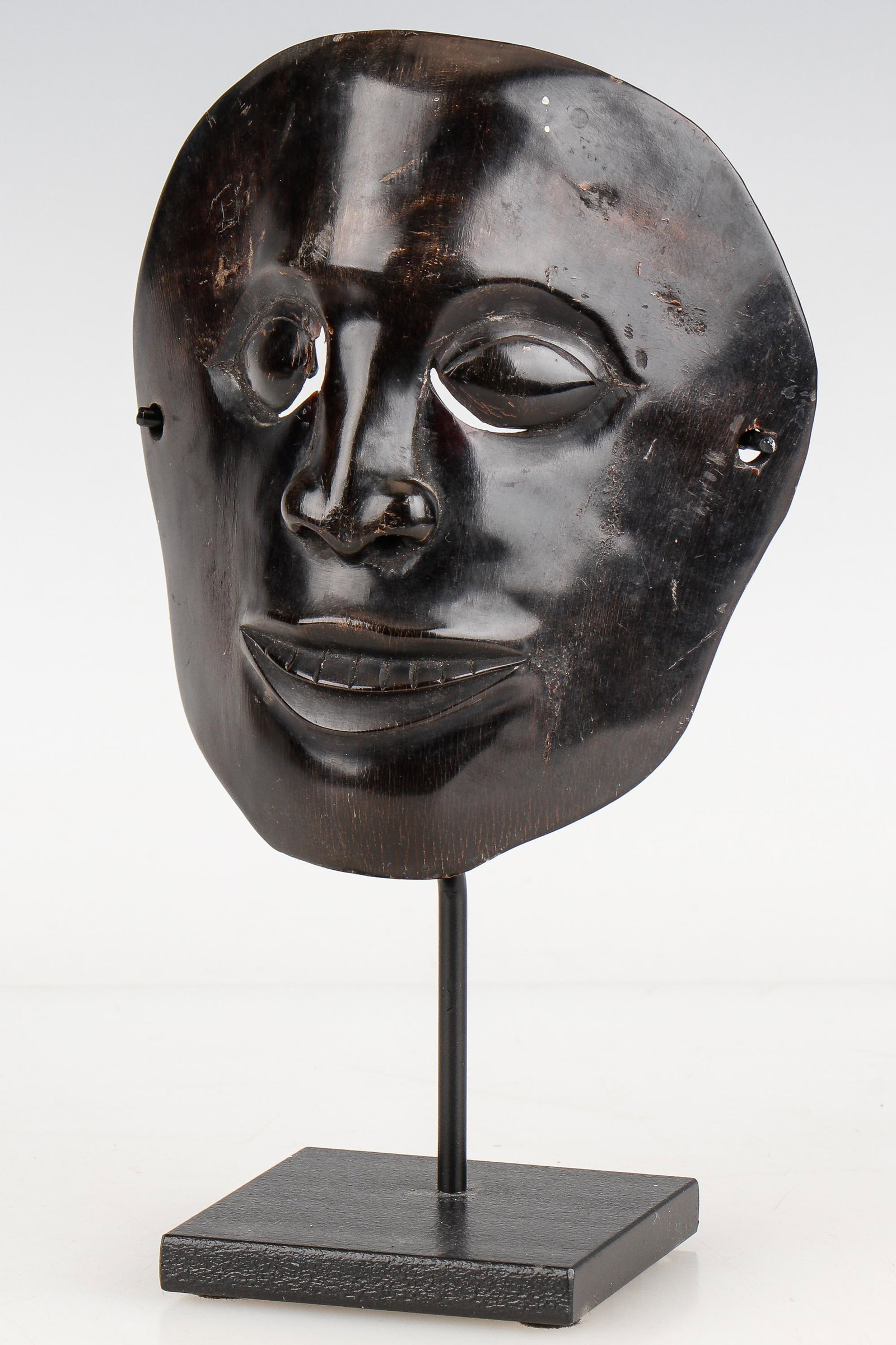 Expressive Javanese Carved Horn Ritual Theater Mask: Expressive Javanese Carved Horn Ritual Theater Mask. On stand. Size: 5.3'' x 4.5'' x 3'' (13 x 11 x 8 cm). Height on stand: 8" (20 cm).
