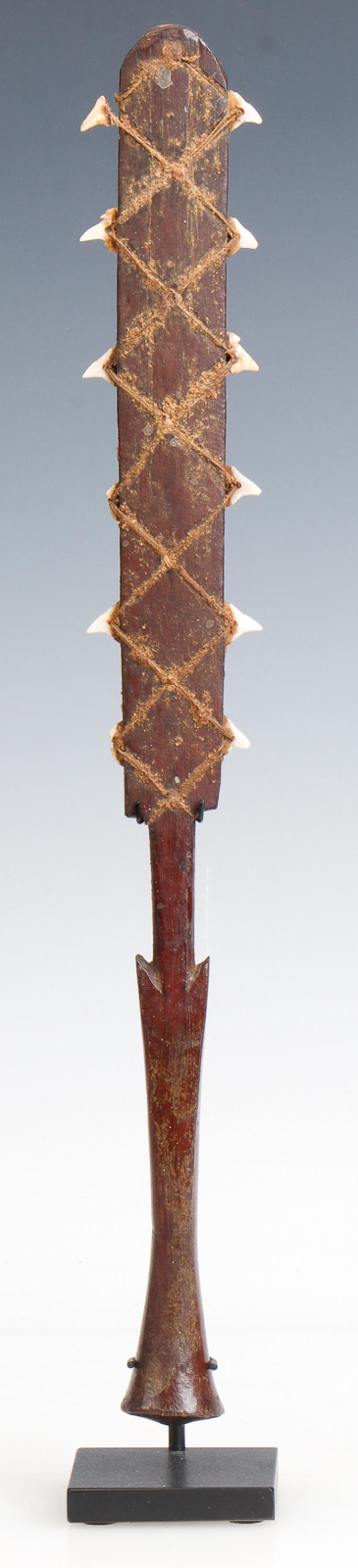 Micronesian Sharks Tooth Weapon, Kiribati/Gilbert Islands: Micronesian Sharks Tooth Weapon, Kiribati/Gilbert Islands. Carved wood, sharks teeth. On metal stand. From the collection of Joseph Salamanca. Size: 15'' x 2'' x 1'' (38 x 5 x 3 cm). Height on stand: 