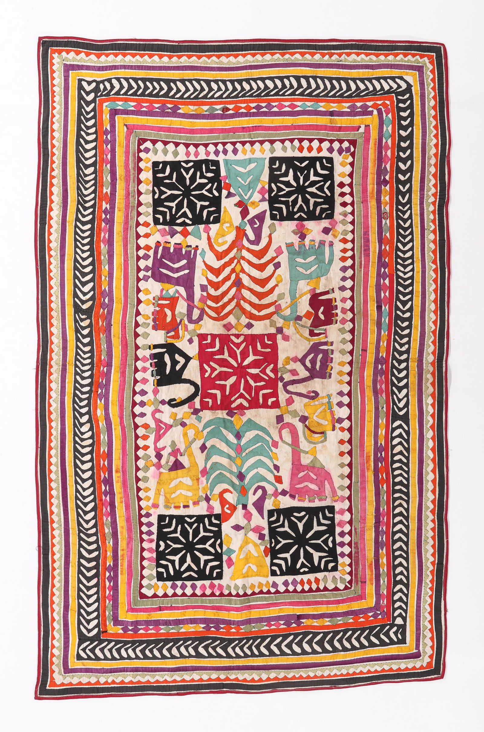Quilt, Rabari People, Gujarat, Early-Mid 20th C.: Quilt, Rabari People, Gujarat, cotton and some synthetics appliqued on commercial cotton. Trees of life, camels and elephants enhanced by some color running. Ref: Another Treasury of Indian Folk Texti