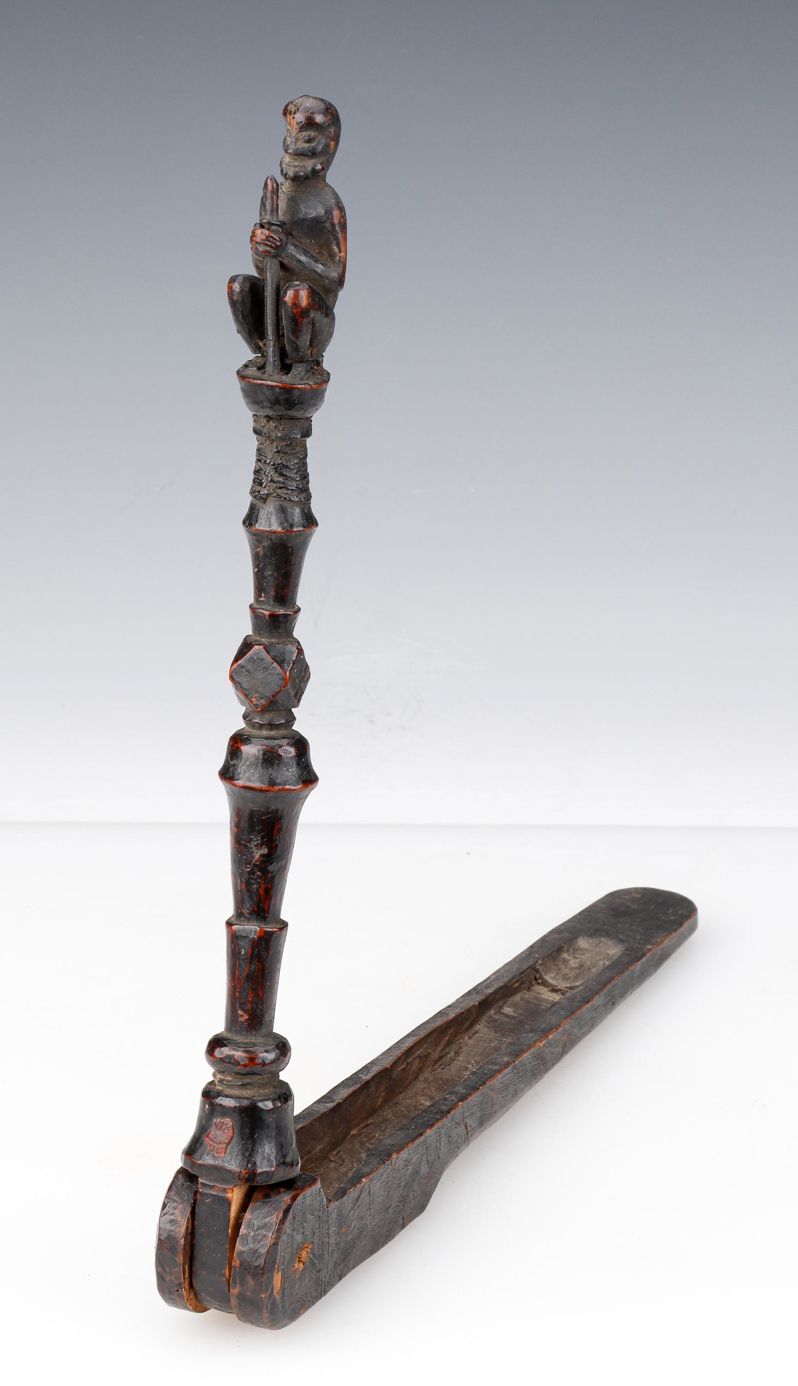 Newari Figural Twining Rod, Nepal, Late 19th C.: Newari Figural Twining Rod, Nepal, Late 19th C. The hand-carved standard surmounted with a seated figure, hinged at the bottom to a another piece of wood with a narrow carved out well. Size: 14'' x 15