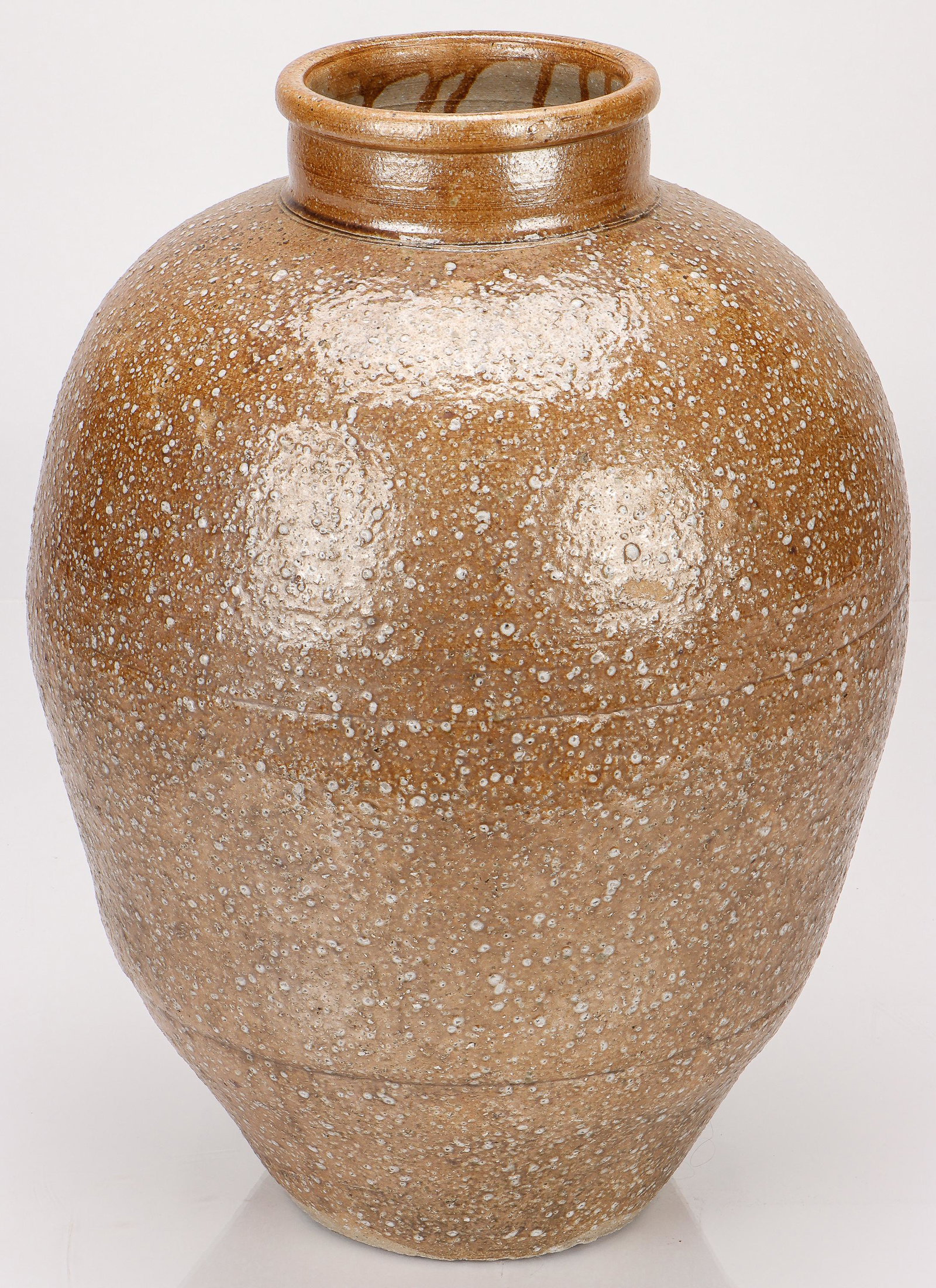 Japanese Meiji Shigaraki Ash Glaze Stoneware Jar, Ht. 20": Japanese Meiji Shigaraki Ash Glaze Stoneware Jar.Covered in a natural ash glaze and peppered throughout with feldspar particles burst all over the earthy brown surface, with an upright neck and rolled