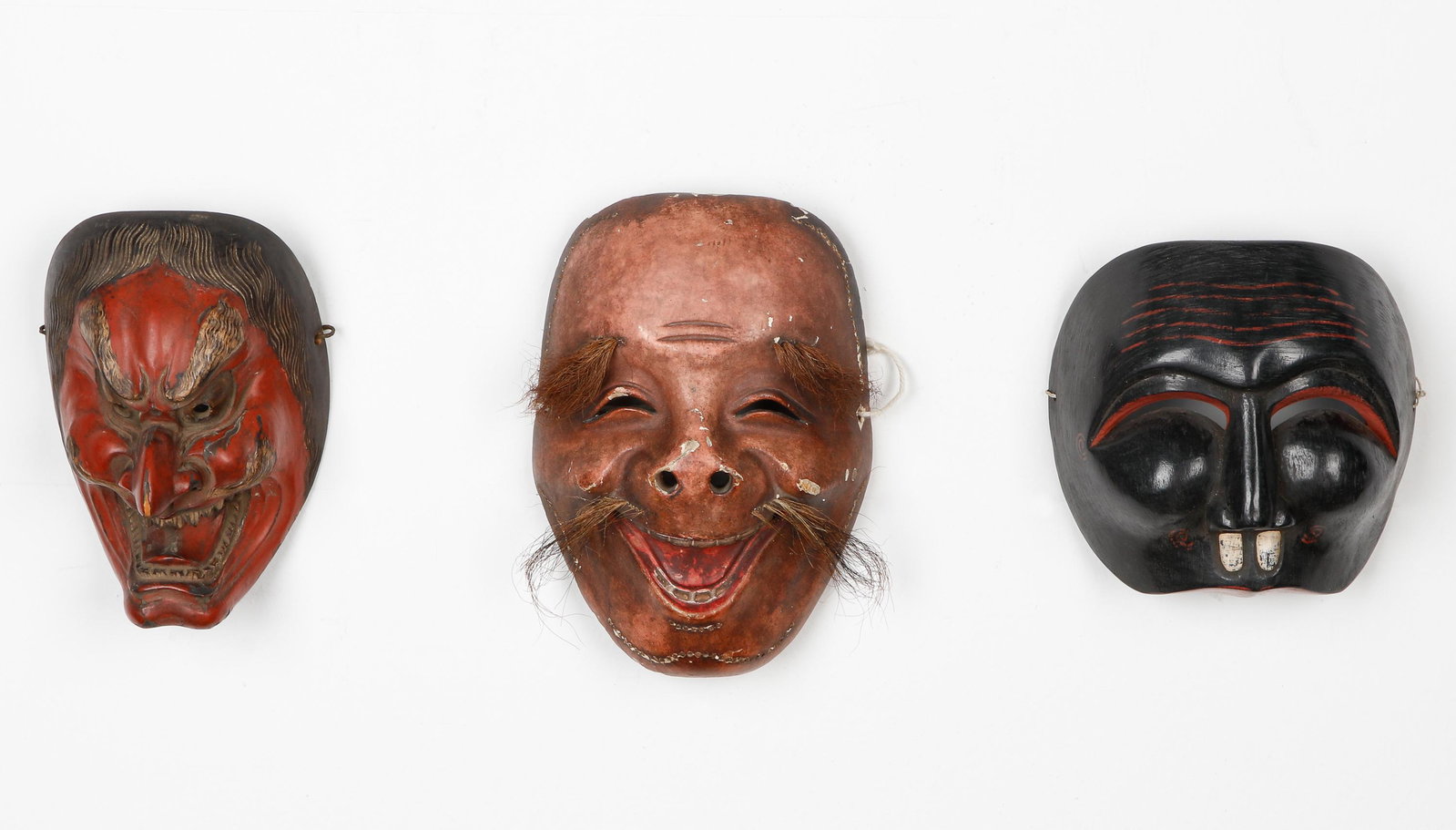 3 Antique Japanese Theater Masks: 3 Antique Japanese Theater Masks. Carved wood, pigment, lacquer and hair. Size: 1) 3.25'' x 5.5'' x 8'' (8 x 14 x 20 cm); 2) 2.5'' x 6'' x 6'' (6 x 15 x 15 cm); 3) 3'' x 4.5'' x 7'' (8 x 11 x 18 cm). 