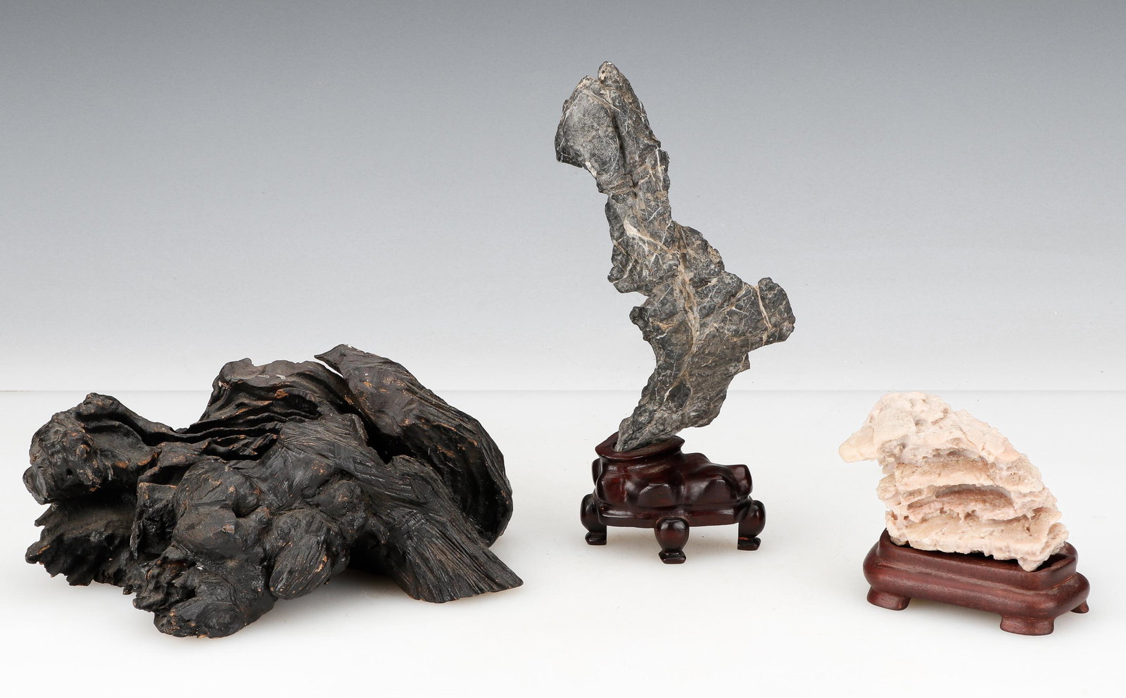 2 Chinese Scholar's Stones and Root: 2 Chinese Scholar's Stones and Root. Size: 1) 3'' x 5'' x 9'' (8 x 13 x 23 cm); 2) 9'' x 4'' x 1.75'' (23 x 10 x 4 cm); 3) 3'' x 2.75'' x 3.5'' (8 x 7 x 9 cm). Provenance: Sylvia and Philip Chaplain C