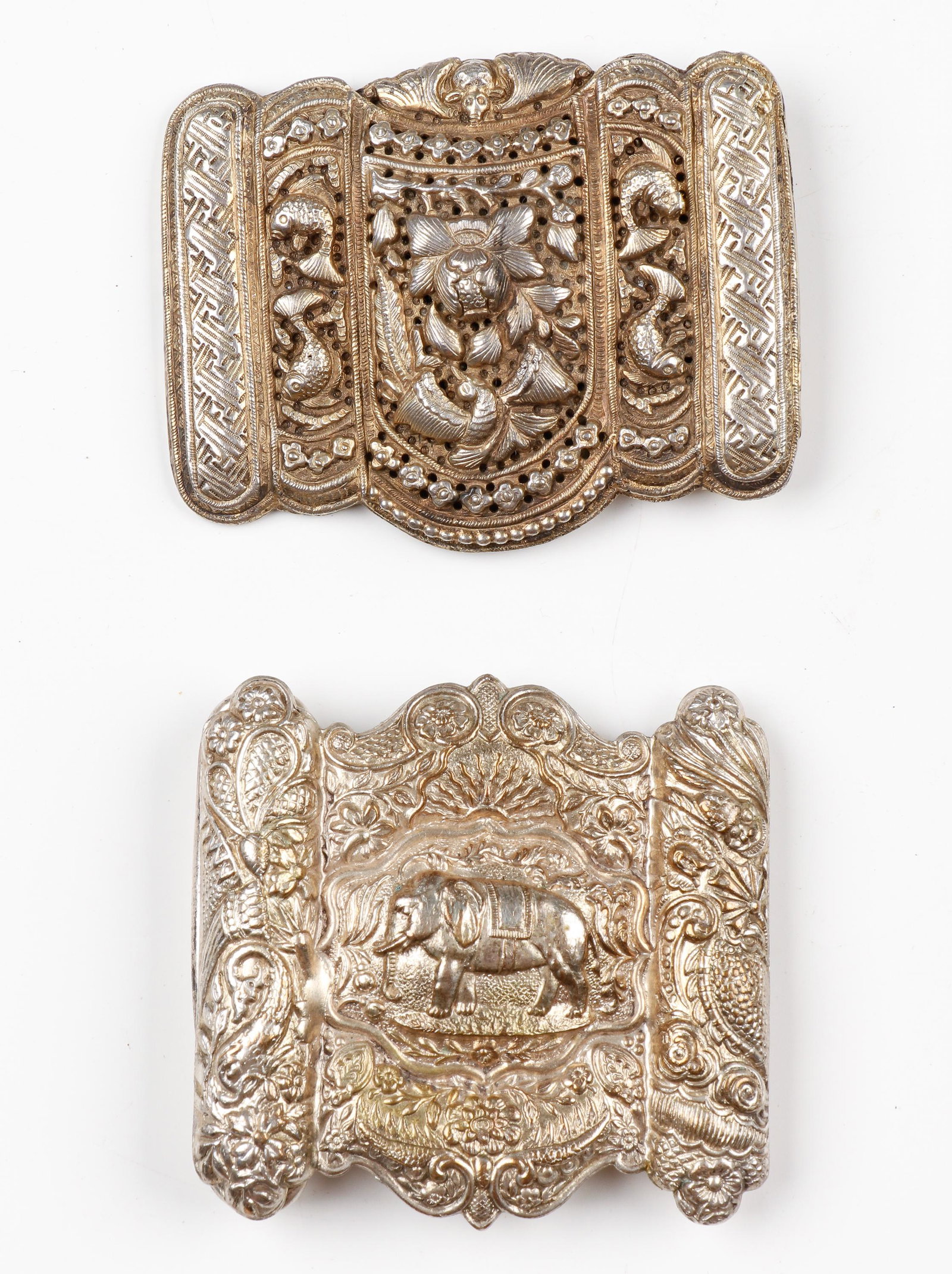 Gilt Silver East Malay Belt Buckle, C.1900: Gilt Silver East Malay Belt Buckle, C.1900. Size: 2.75'' x 2'' (7 x 5 cm). Together with another buckle depicting an elephant. Size: 2.5'' x 2.5'' x '' (6 x 6 x cm). Provenance: Sylvia and Philip Chap
