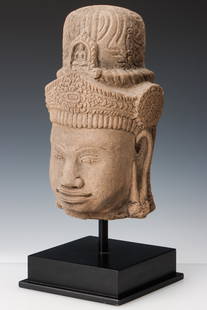 Early Vietnamese Carved Sandstone Head of Avalokitesvara: Early Vietnamese Carved Sandstone Head of Avalokitesvara, 12th C. Provenance: I.M. Chait, Sept. 8, 2013, Lot 315. Size: 12'' x 7'' x 6.5'' (30 x 18 x 17 cm). Height on stand: 16" (41 cm).