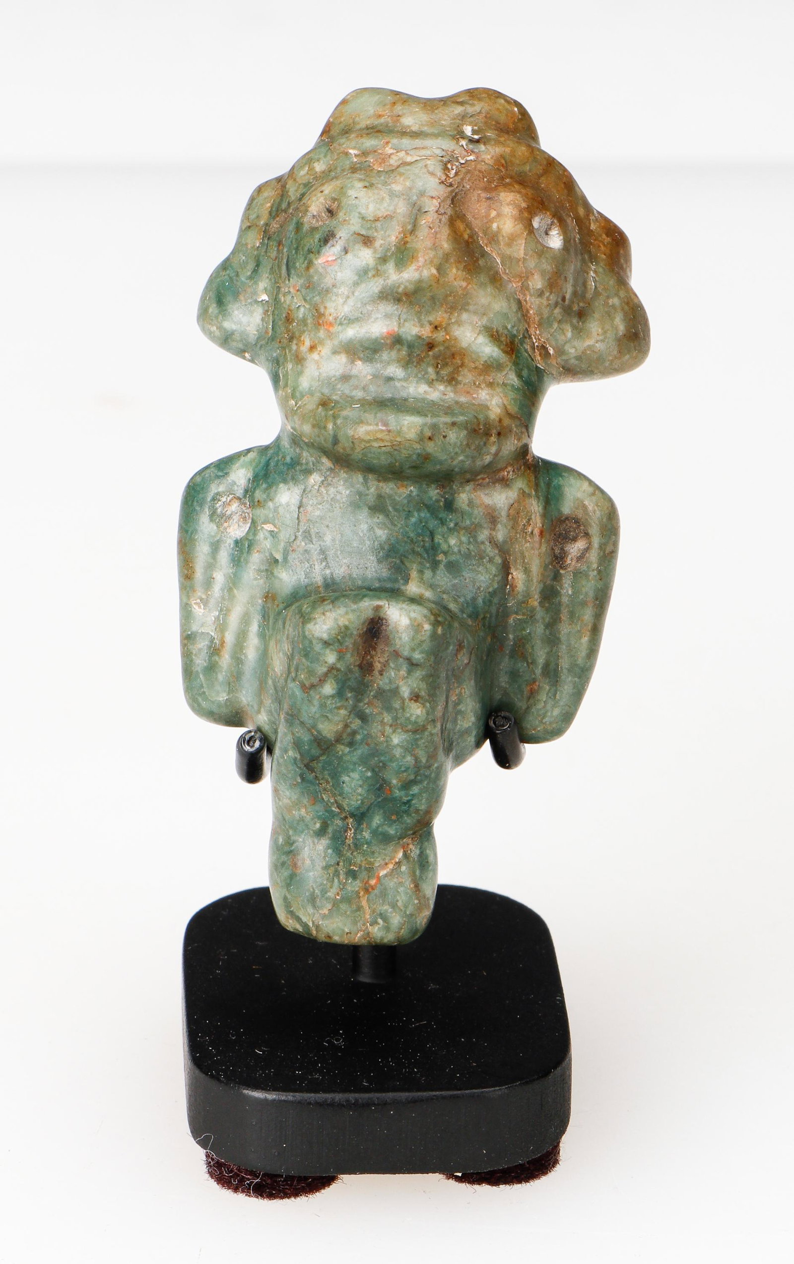 Taino Pre-Columbian Extremely Rare Jade Anthropic Pendant: Taino Pre-Columbian Extremely Rare Jade Anthropic Pendant. Knees up in sitting position. Gaping mouth and bulging eyes suggest the subject is in psycho-active trance. The tense concentration with head