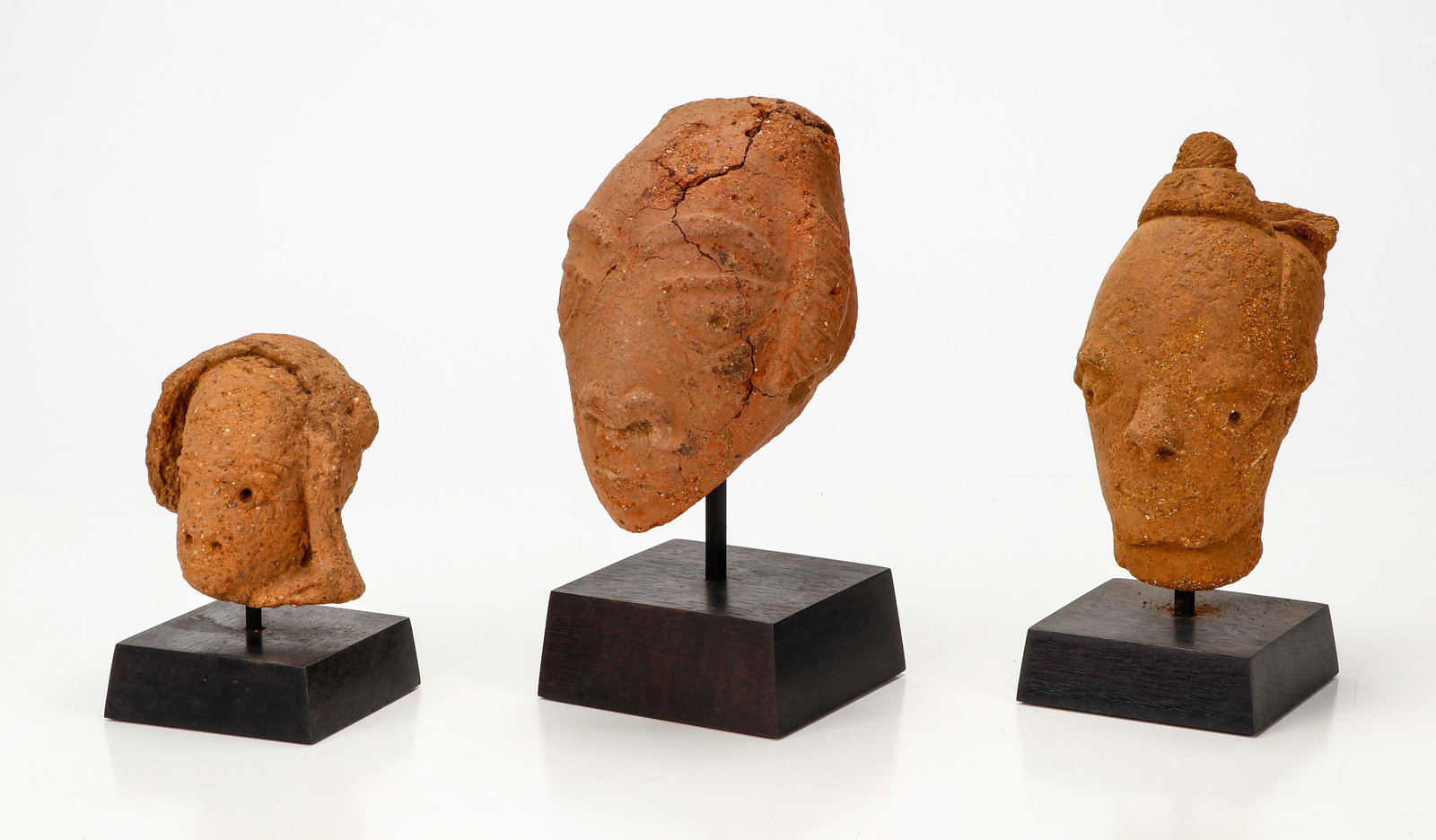 3 Ancient African Nok Terracotta Heads: 3 Ancient African Nok Terracotta Heads, 500 BCE - 200 CE. Size: Ranging from 4.5'' x 3.5'' x 3.5'' (11 x 9 x 9 cm) to 7.5'' x 4.5'' x 5.5'' (19 x 11 x 14 cm). Provenance: Ex. collection Karim Deen.