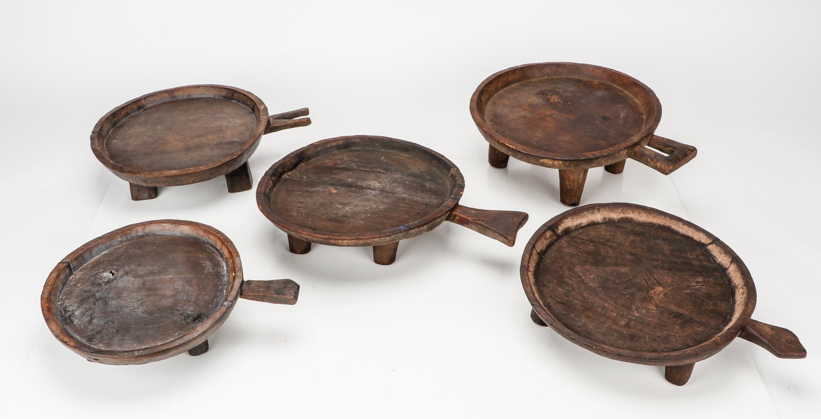 5 African Footed Servers With Handles, Ethiopia: 5 African Footed Servers With Handles, Ethiopia. Wood. Size: Ranging from 4.5'' x 17'' x 13'' (11 x 43 x 33 cm) to 4.5'' x 20.5'' x 14.5'' (11 x 52 x 37 cm). Provenance: Craft Caravan, Inc., New York,