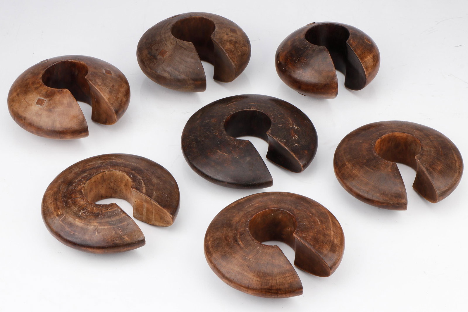 7 African Tutsi Style Wooden Cuffs, Rwanda: 7 African Tutsi Style Wooden Cuffs, Rwanda. Size: Ranging from: 7'' x 7'' x 4'' (18 x 18 x 10 cm) to 9'' x 9'' x 2'' (23 x 23 x 5 cm): $150- $250