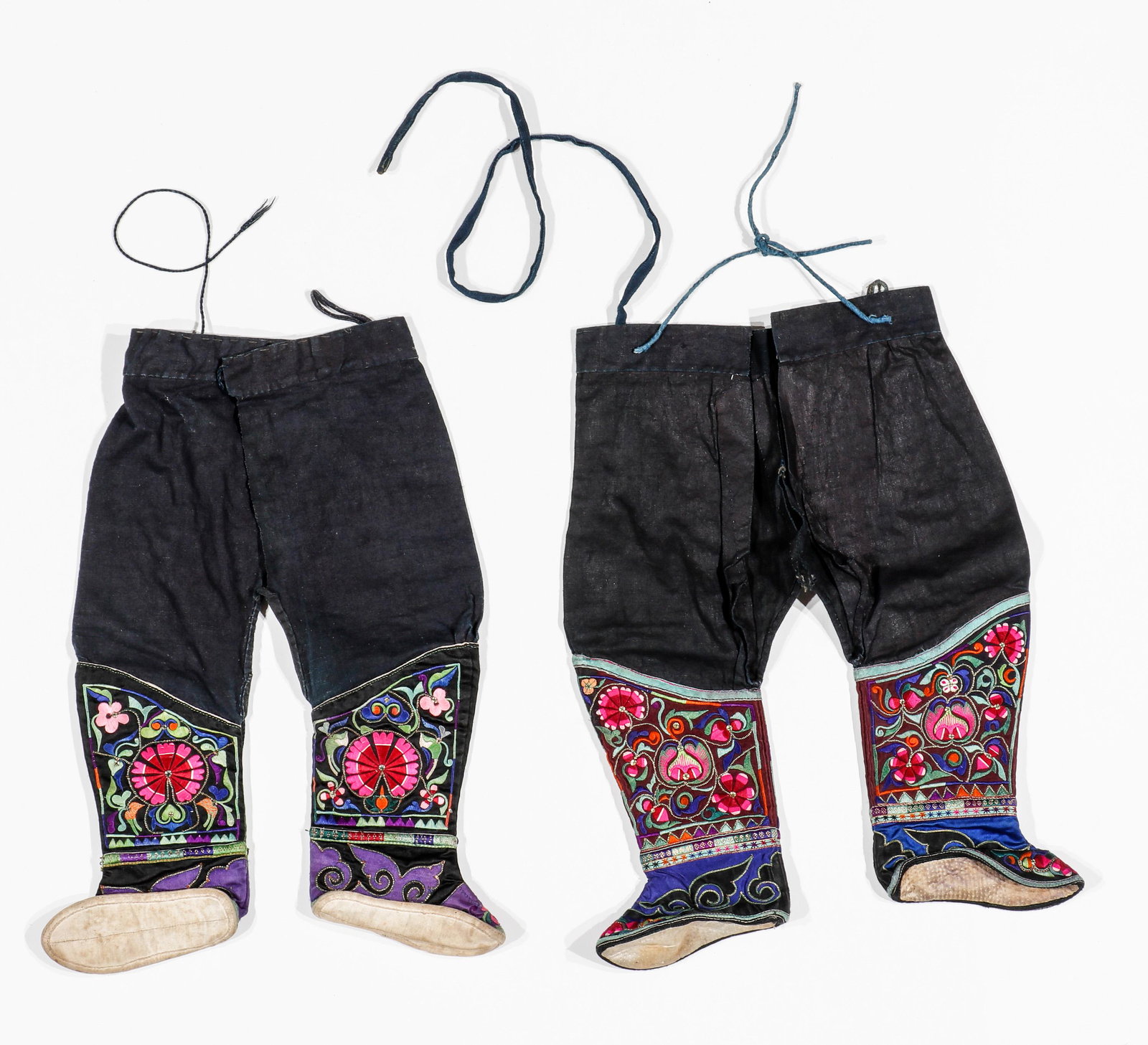 2 Pairs of Zhuang Child's Pants With Attached Shoes, Yunnan Province, China, Early-Mid 20th C.: 2 Pairs of Zhuang Child's Pants With Attached Shoes, Yunnan Province, China, Early-Mid 20th C. 1) Cotton, silk embroidery, applique, foil couching. Open crotch cotton pants with tie front closure sewn