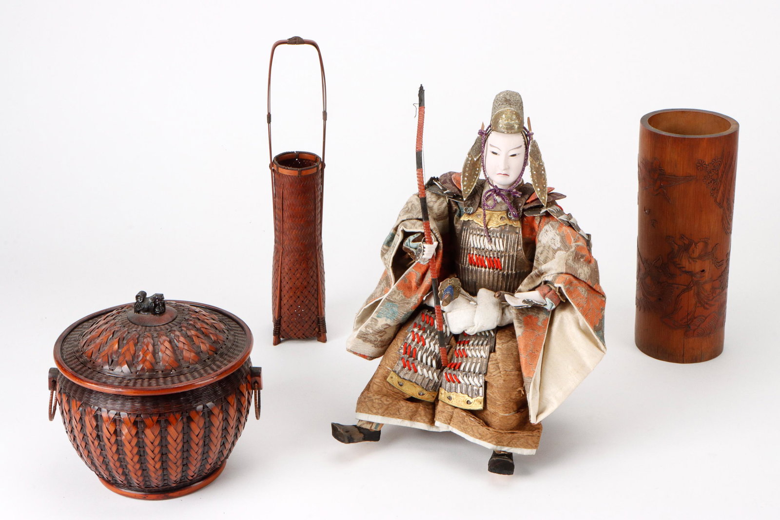 Asian Collector's Lot: Asian Collector's Lot. Including ikebana basketry, doll, and brush pot. Ranging in size from: 9'' x 9'' x 8.5'' (23 x 23 x 22 cm) to 15.25'' x 10.5'' x 11'' (39 x 27 x 28 cm). Provenance: Ex collectio