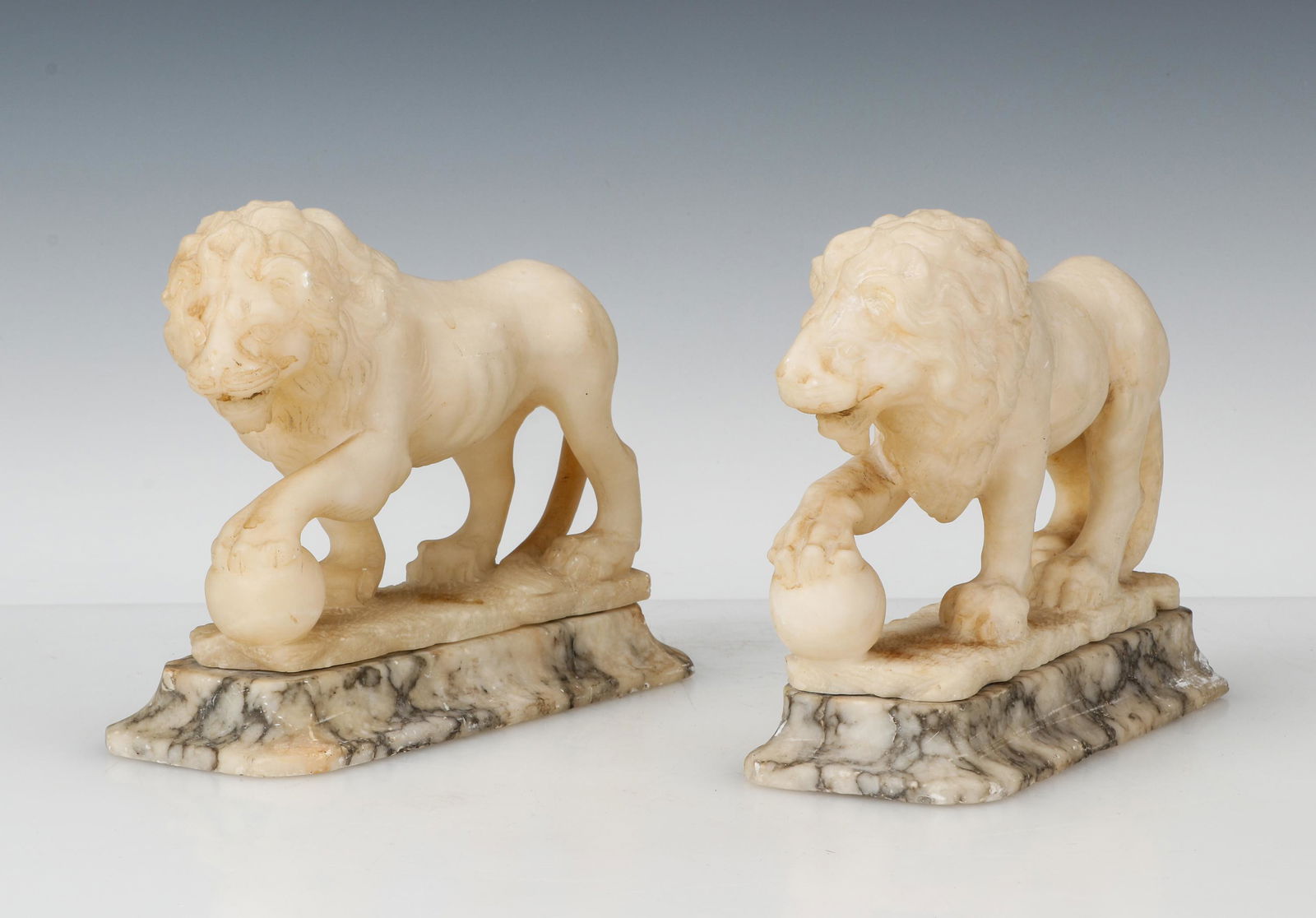 Pair of Italian Alabaster Medici Lions: Pair of Italian Alabaster Medici Lions. On marble bases. Size: 6.5'' x 7.5'' x 3.5'' (17 x 19 x 9 cm).