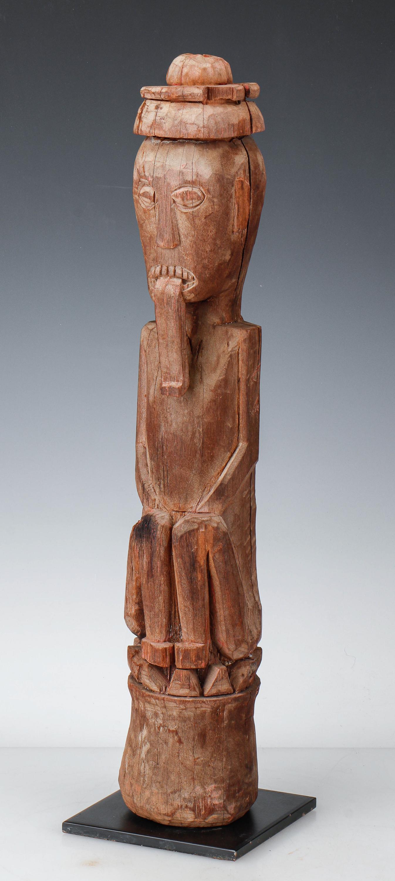 Small Elegant Dayak Hampatong, Central Borneo: Small Elegant Dayak Hampatong, Central Borneo. Figure with tongue extended like ancient Chinese tomb guardians. Carved wood with traces of pigment. On stand. Size: 24'' x 4.5'' x 5'' (61 x 11 x 13 cm)