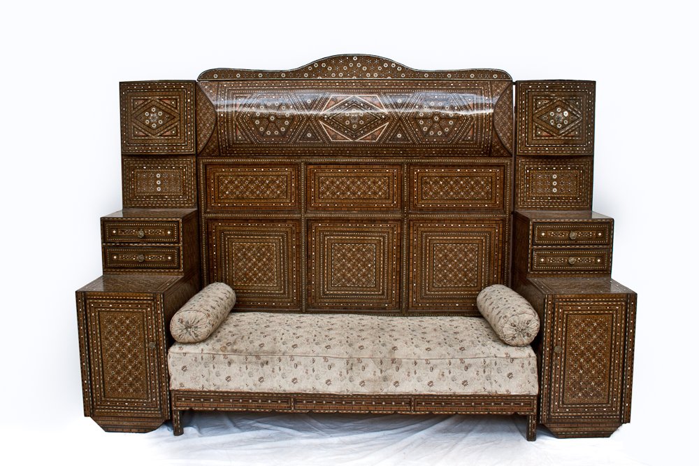 A Syrian Mother-Of-Pearl Sofa: Mother of Pearl and Bone inlaid. Walnut. Early 20th C., Height: 72” Width: 100” Depth 28”