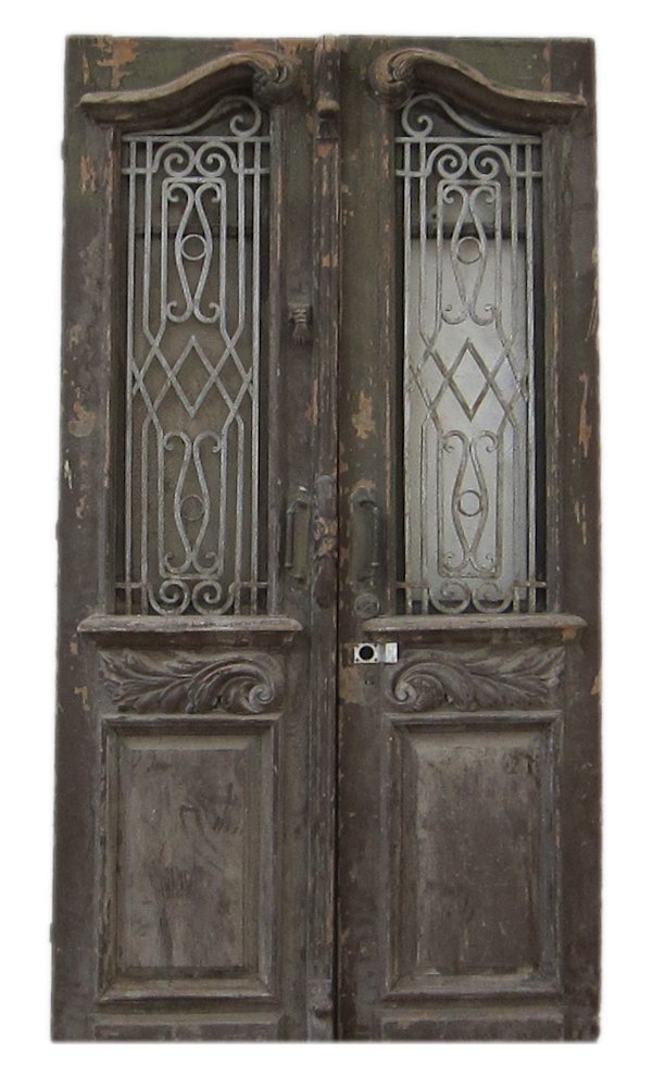 A 19th Century Carved Wood Aleppo Door: Syria, glass and iron, hand of Fatima door knocker, 46” x 92”