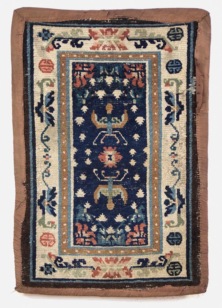 Tibetan Saddle Rug: Tibetan Saddle Rug - Tibet, 19th c, blue field masho saddle top with "frog foot" and butterfly/bat motif. Literature: HALI magazine, issue 169, Tom Cole, "Tale From the Hills" Prov: Bill Liske Dimensi