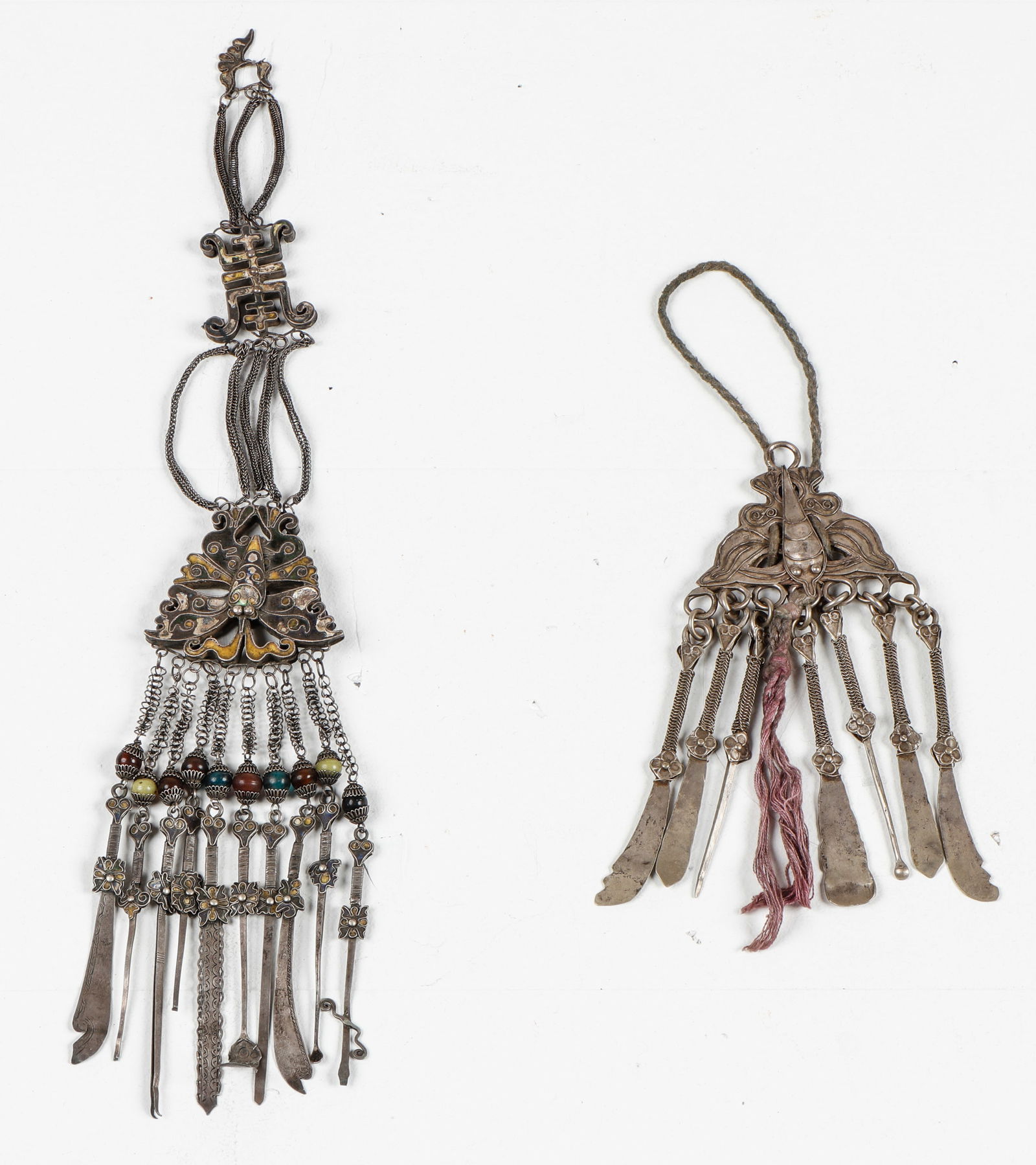2 Asian Silver Chatelaines: 2 Asian Silver Chatelaines. Each with dangling tools for snuff. Size: 1) 10.5'' x 3.5'' (27 x 9 cm); 2) 17.5'' x 3'' (44 x 8 cm). Weight: 259 grams