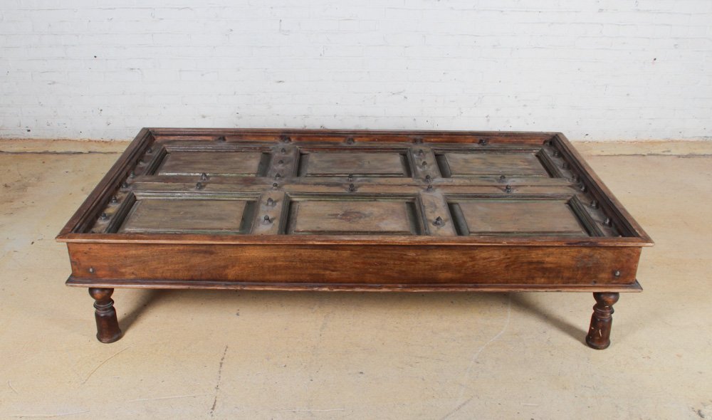 Large Anglo Indian Coffee Table: Large Anglo Indian Coffee Table, modern, teak, with a 19th c insert of a teak and iron door. Dimensions: 18 x 75 x 42 inches. Property of Michaelian and Kohlberg.