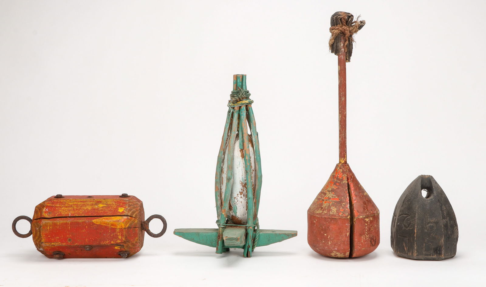4 Buoy-Form Folk Art Objects: 4 Buoy-Form Folk Art Objects. Size: ranging from 8'' x 5.5'' x 5.5'' (20 x 14 x 14 cm) to 23.5'' x 6.5'' x 6.5'' (60 x 17 x 17 cm). Provenance: The Robert L. Pfannebecker Collection.